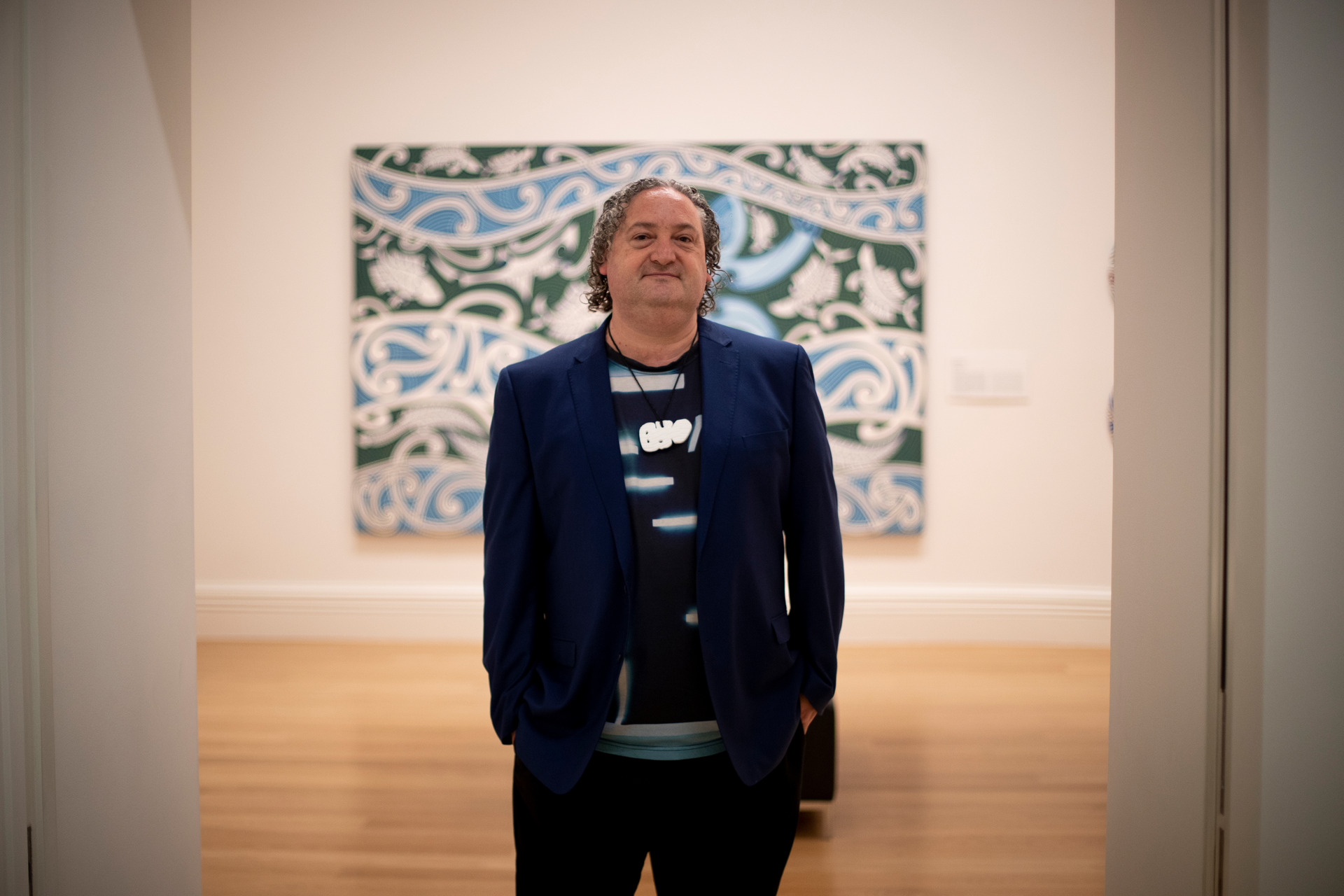 Nigel Borell, curator of Auckland Art Gallery's Toi Tū Toi Ora exhibition, in front of Tangaroa, a 1982 work by Cliff Whiting, who Borell cites as an early inspiration. Photo / Dean Purcell