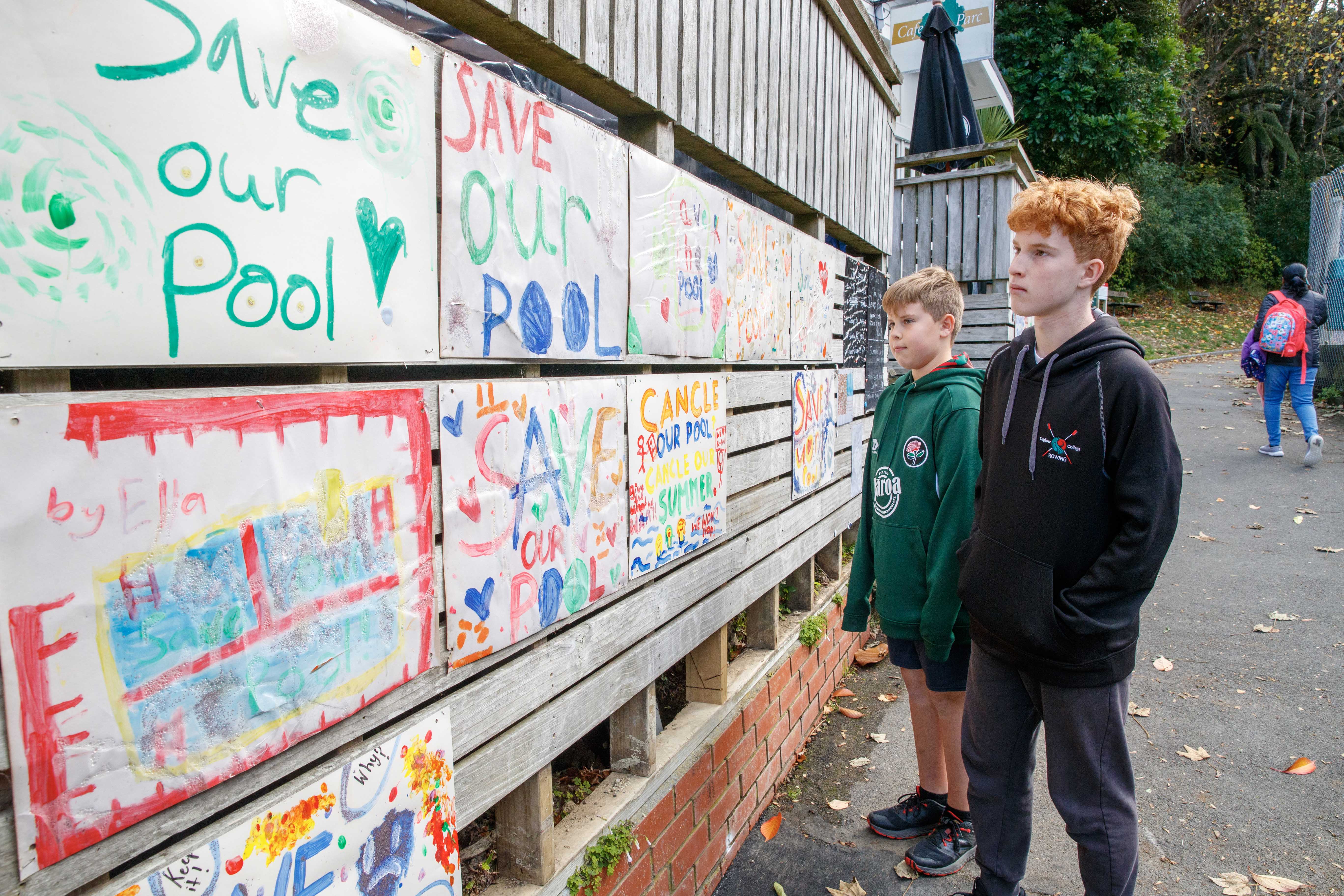 Alfie Picker, 14, and his brother Henry, 11, at Khandallah Pool where residents have placed signs asking the council to save their pool. Photo / Mark Mitchell  