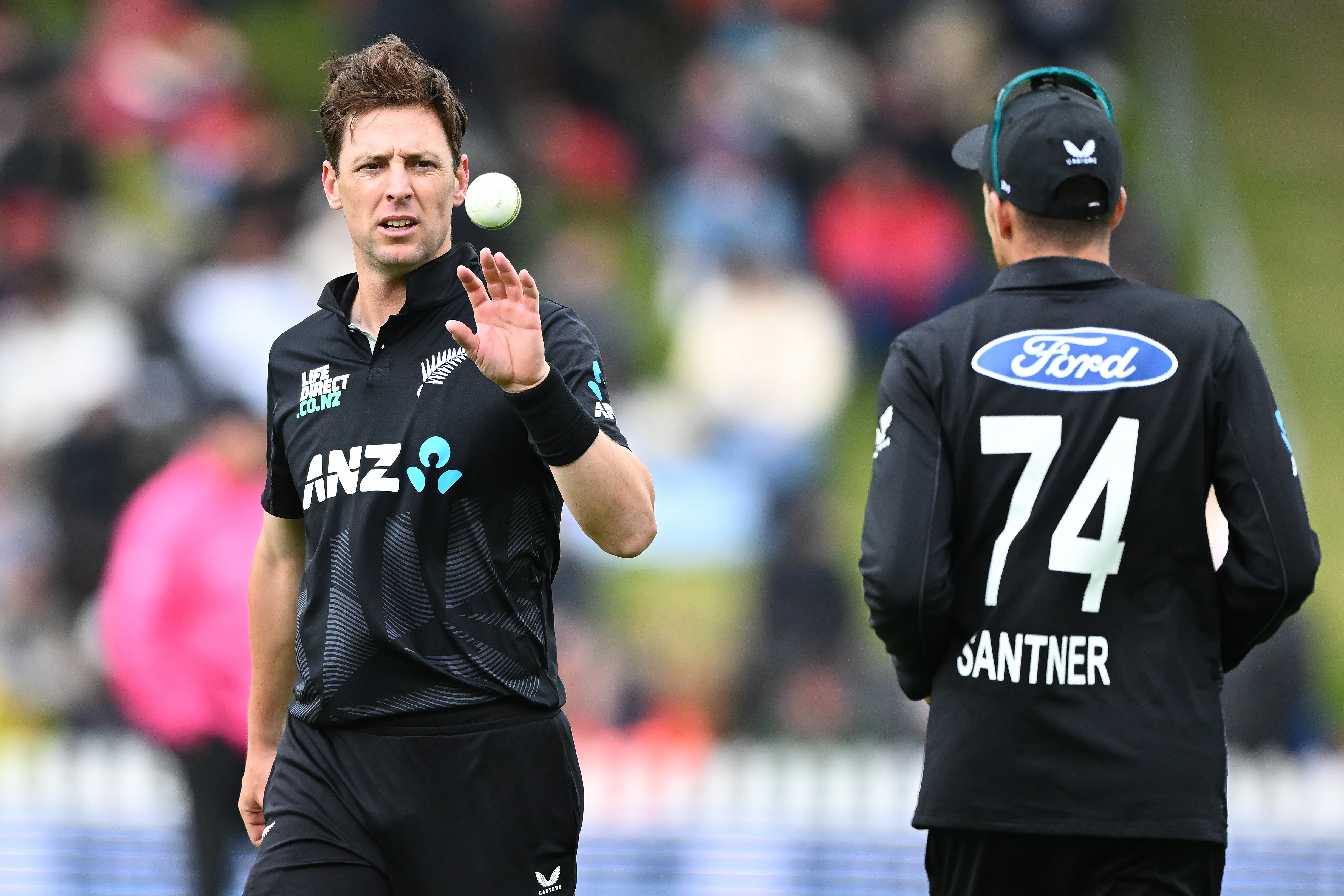 Mitchell Santner is more than happy to hand the ball to Matt Henry. Photo / Photosport