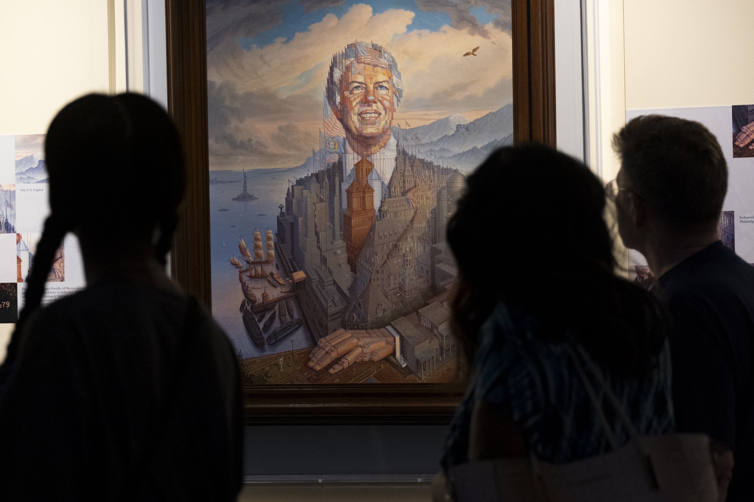 Visitors pass a portrait of President Jimmy Carter during a celebration of his 99th birthday held at The Carter Centre. Photo / AP