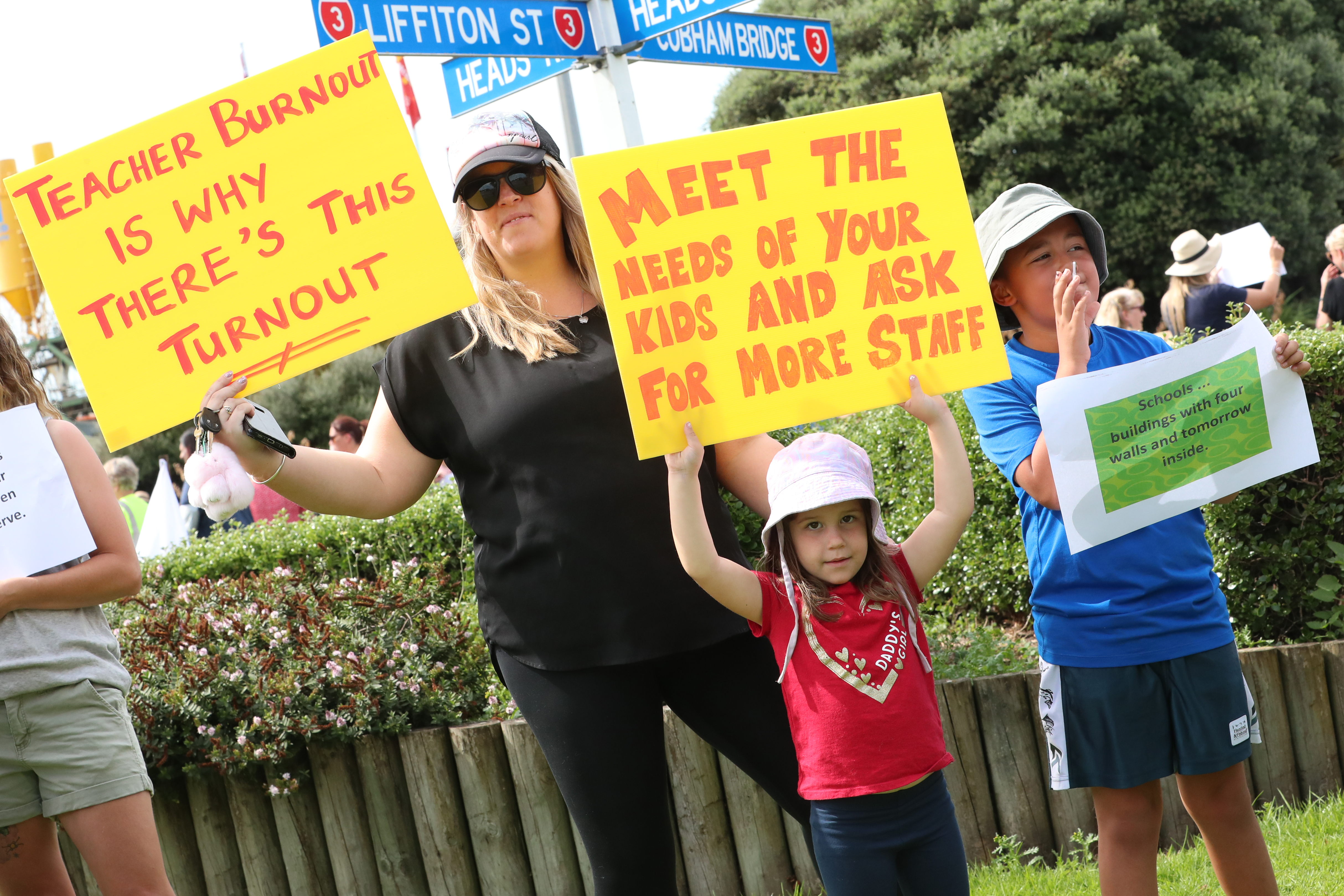 Therese Lewis (teacher), Sofia Lewis and Elijah Hakaria-Woon take part in the Thursday teachers' strike at Whanganui's Lifton St roundabout.  Photo / Bevan Conley