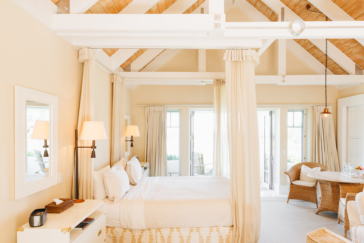 The cottages are light and warm, with exposed beams and diaphanous curtains.