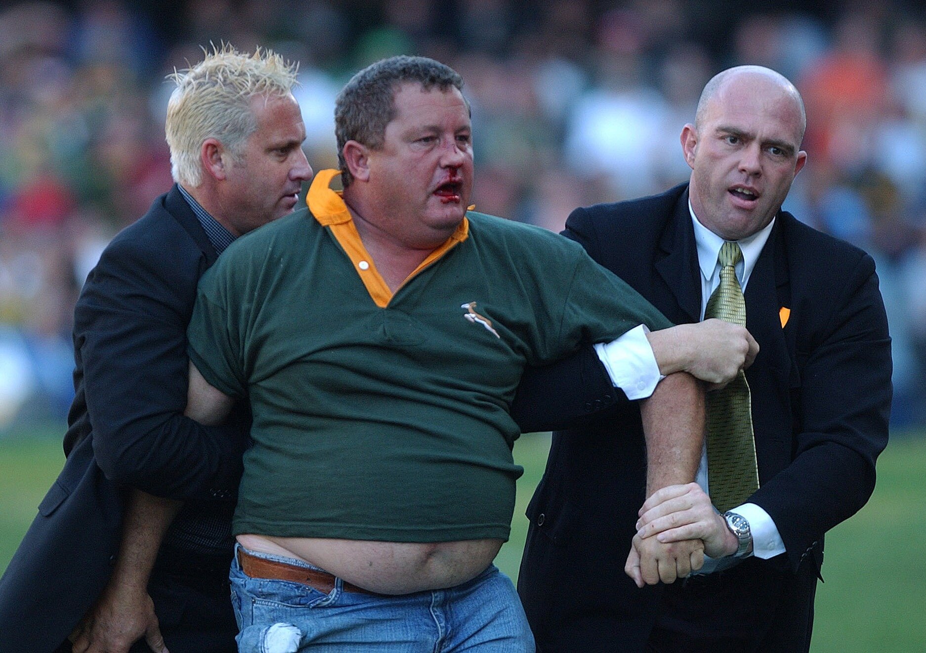 Springboks supporter Pieter Van Zyl is removed from the field by officials after assaulting Irish referee David McHugh during the All Blacks' 2002 victory in Durban. Photo / Getty Images