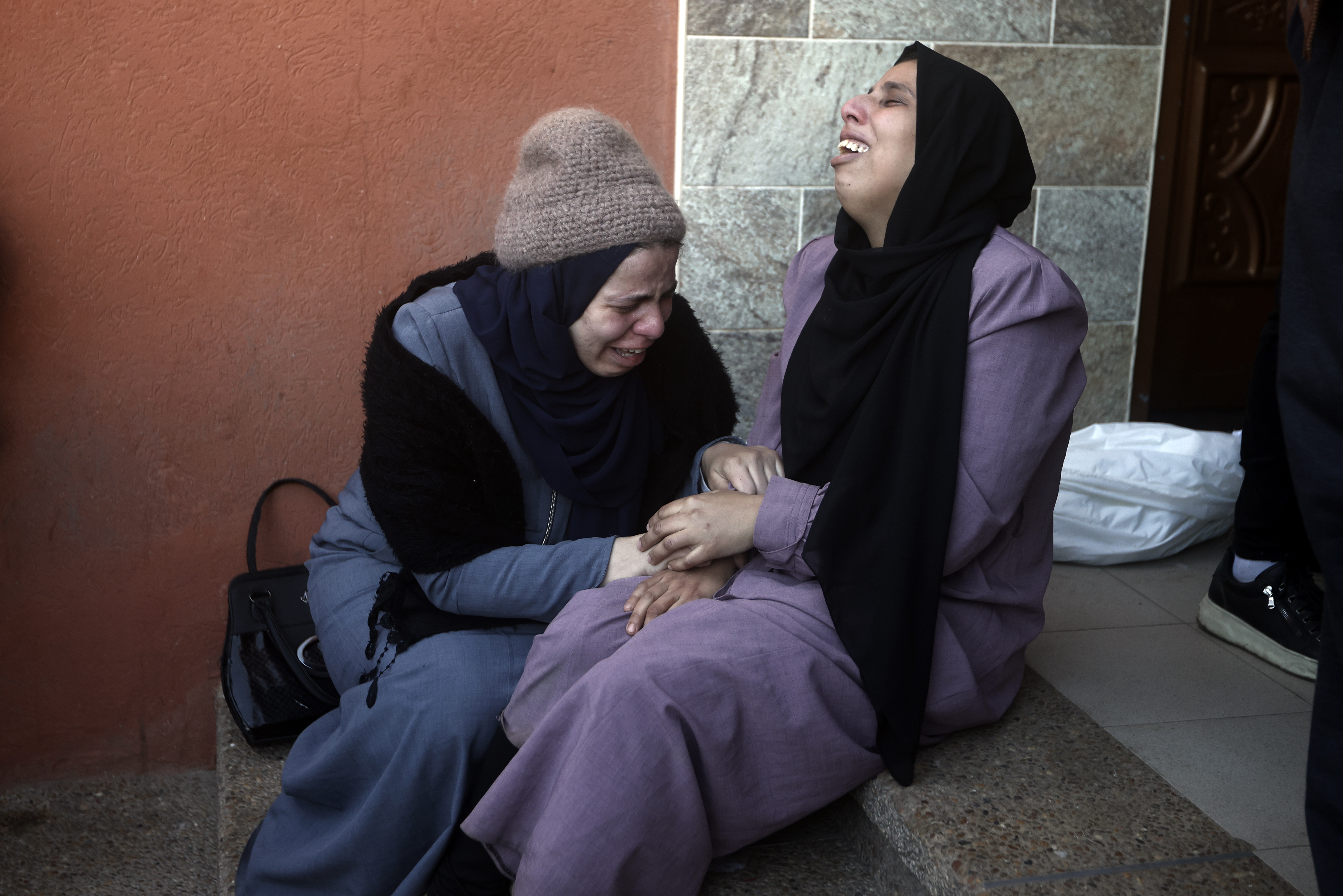 Palestinians mourn relatives killed in the Israeli bombardment of the Gaza Strip outside a morgue in Khan Younis. Photo / AP