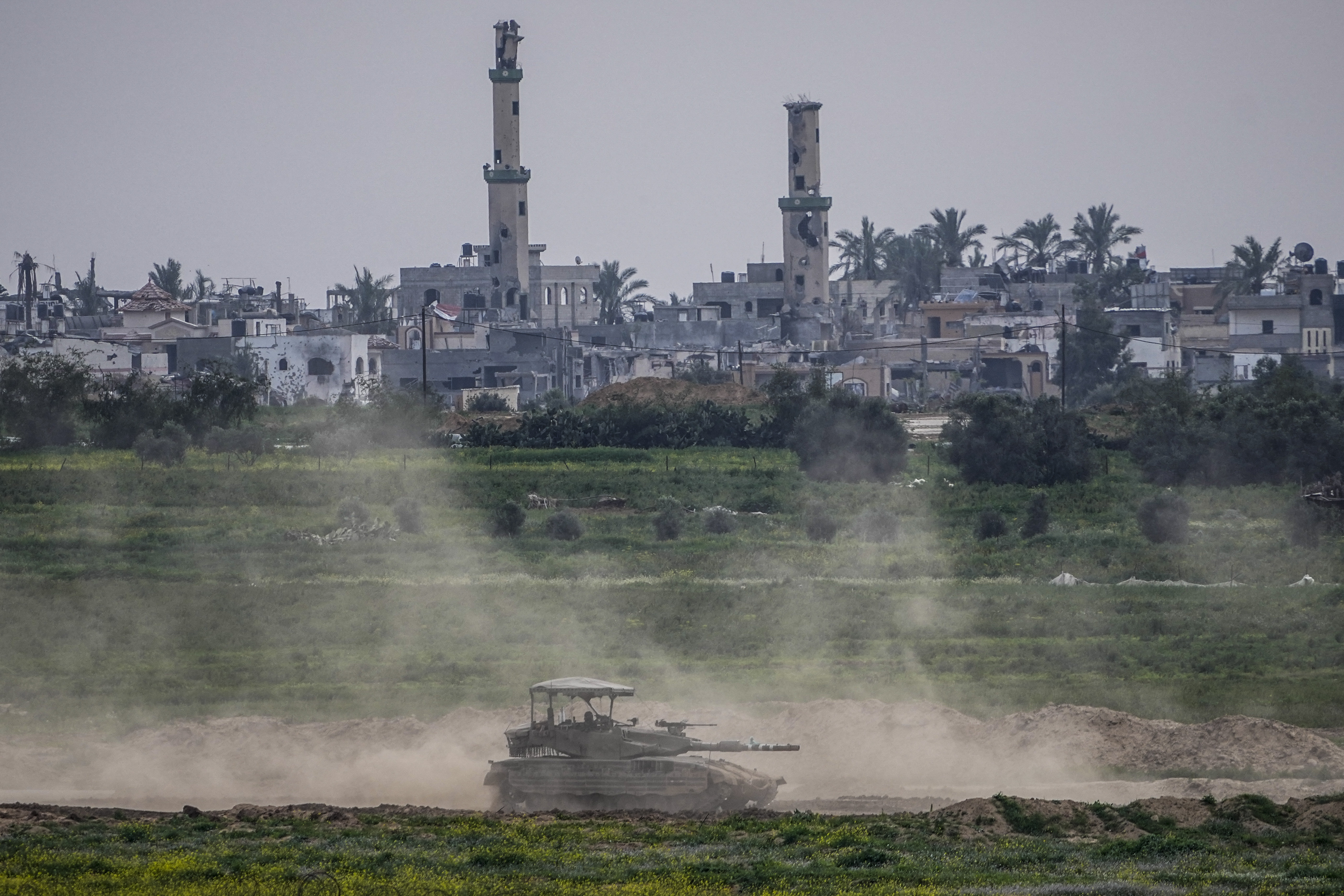 Israeli soldiers drive a tank inside the Gaza Strip, as seen from southern Israel. Photo / AP