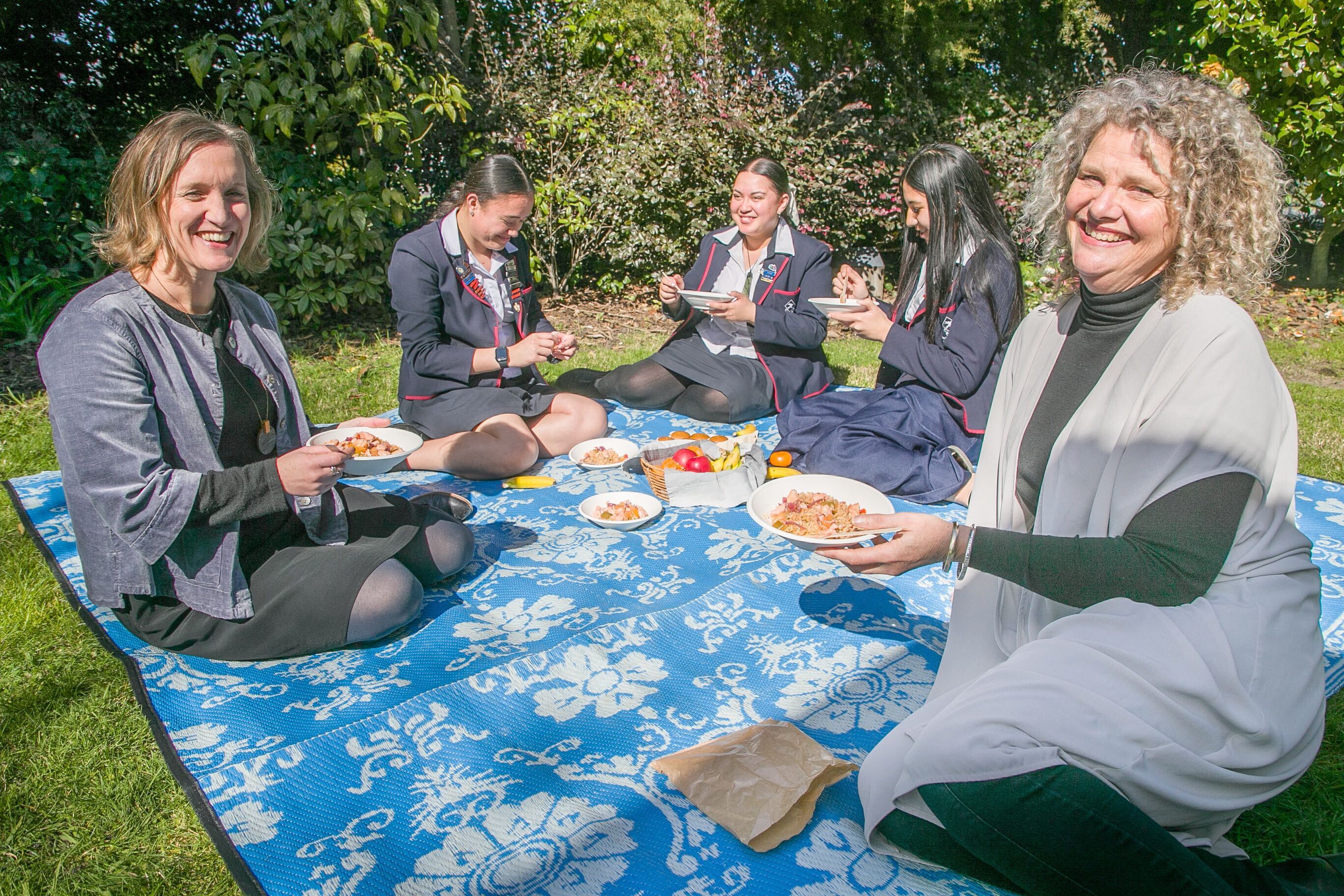 Pippa McKelvie-Sebileau, left, and Hastings Girls' High Principal Catherine Bentley enjoying lunch with students last year. Bentley has invited ACT leader David Seymour to visit and speak with students to see and hear the benefits of free school lunches. Photo / Warren Buckland
