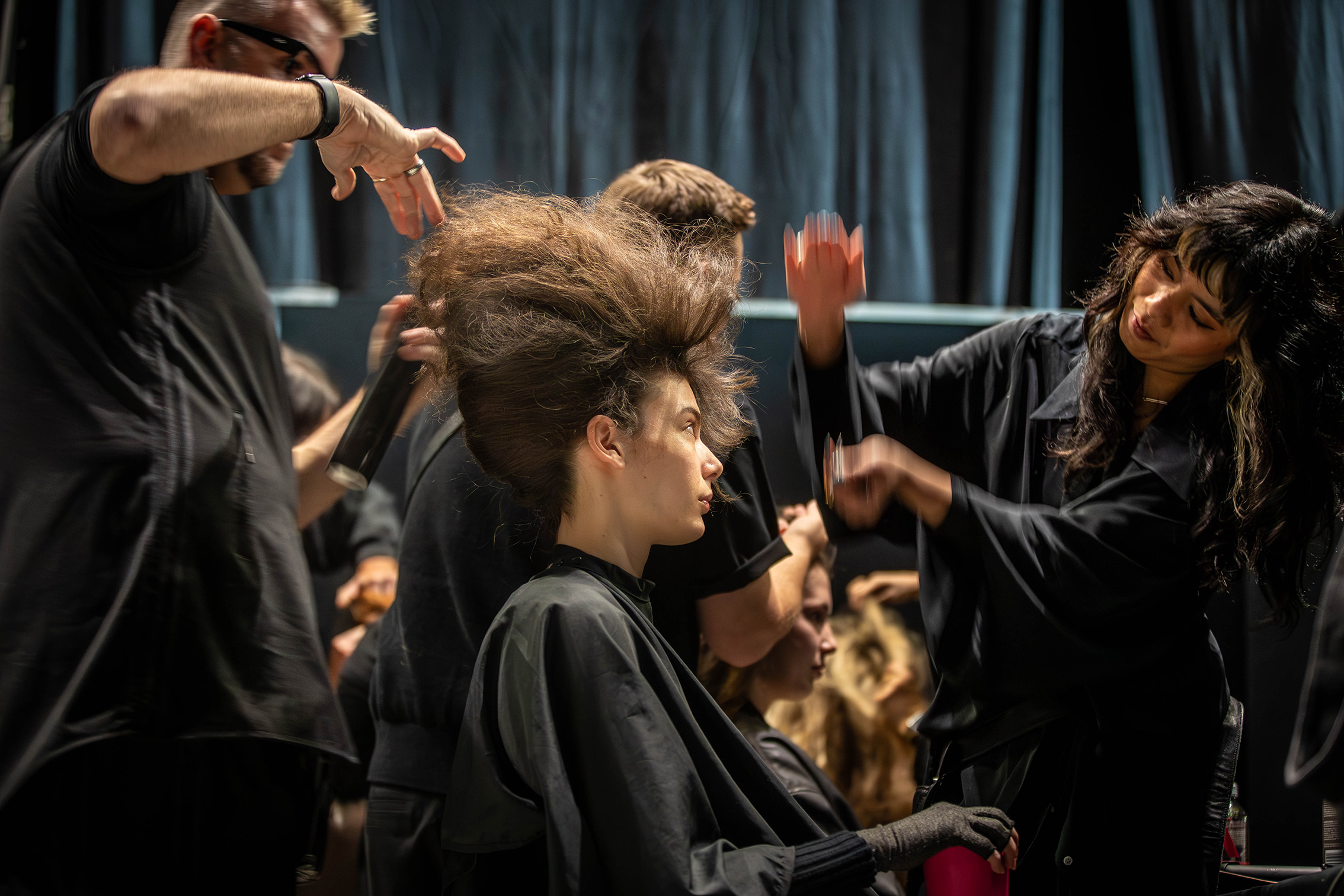 7:23am: Stylists start work on Hope Phillips' hair, ahead of the Kiri Nathan runway show. Photo / Michael Craig