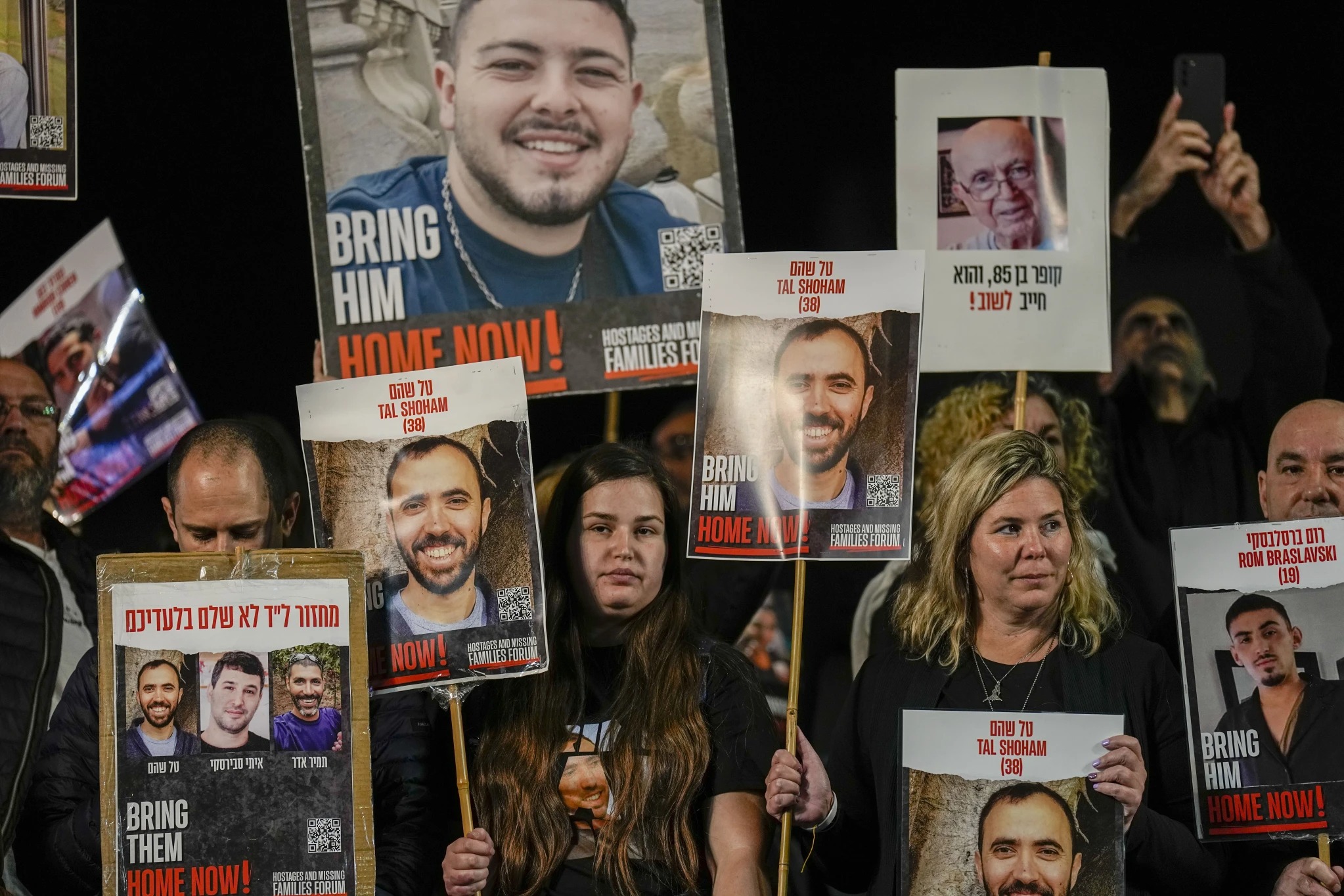 Families and supporters of Israeli hostages held by Hamas in Gaza hold their photos and shout slogans during a rally calling for their release. Photo / AP 