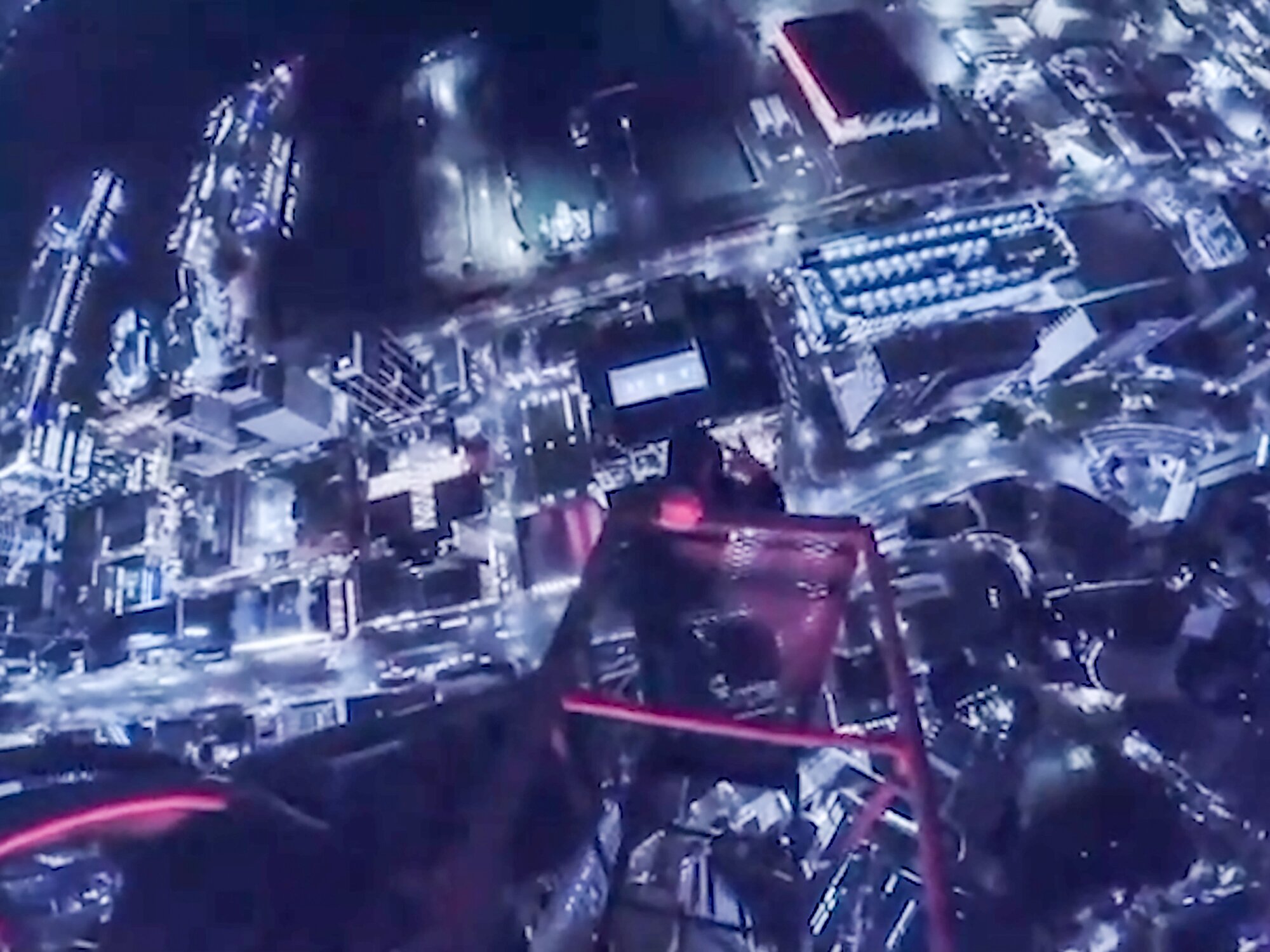 A still image from a video published this month to TikTok showing a daredevil hanging by one hand from a crane at the top of the Seascape high-rise building construction site. 