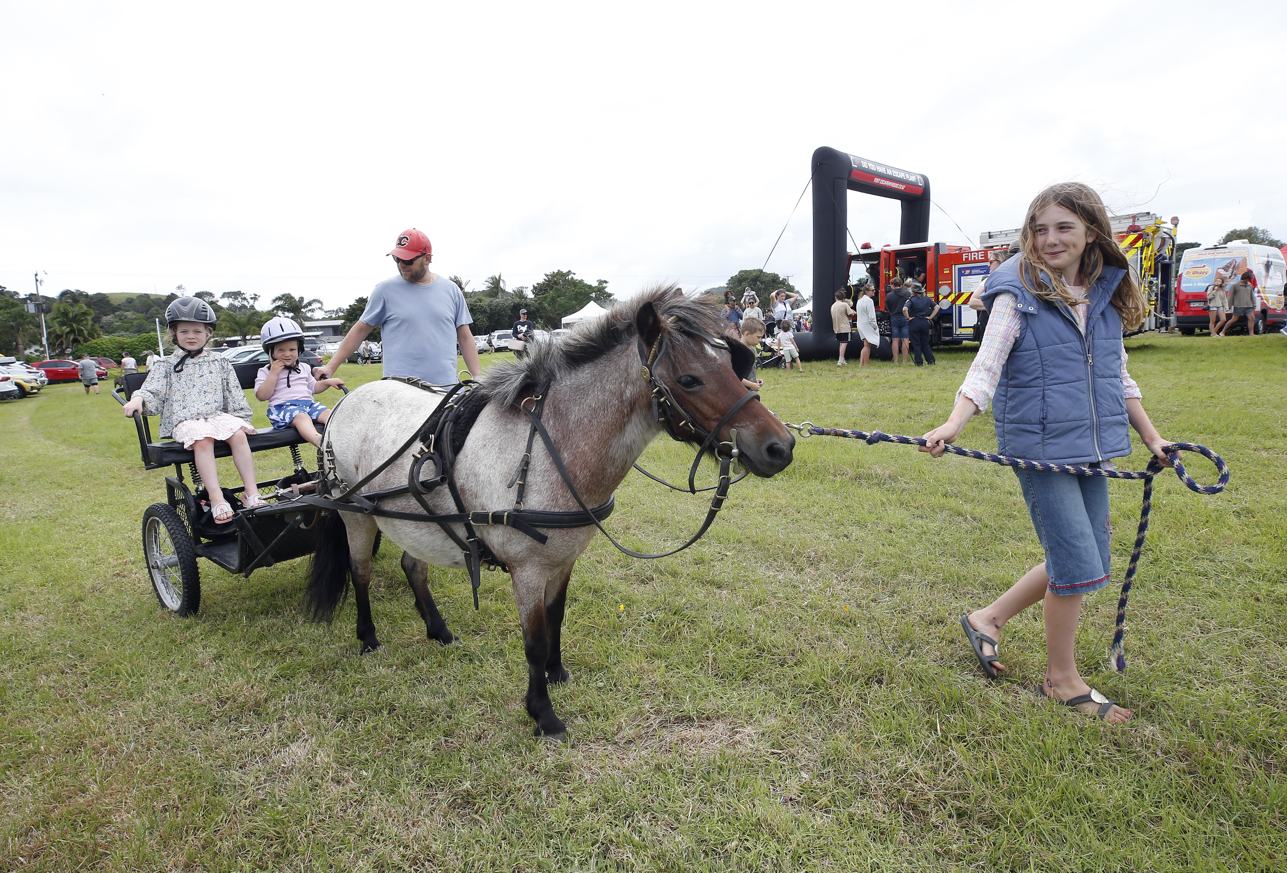 Party Poopers Pony Party's Brenna Ashcroft takes Ottilie Allen, 4, and Kira Korzh, 2, for a ride at Matapouri.