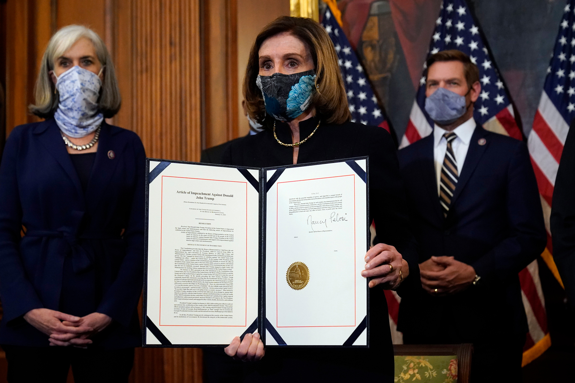 House Speaker Nancy Pelosi displays the signed article of impeachment against President Donald Trump. Photo / AP