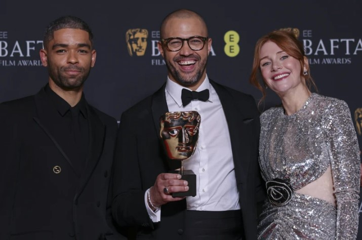 Kingsley Ben-Adir, from left, Cord Jefferson, winner of the adapted screenplay award for ‘American Fiction’, and Bryce Dallas Howard, pose for photographers at BAFTAs. Photo / AP