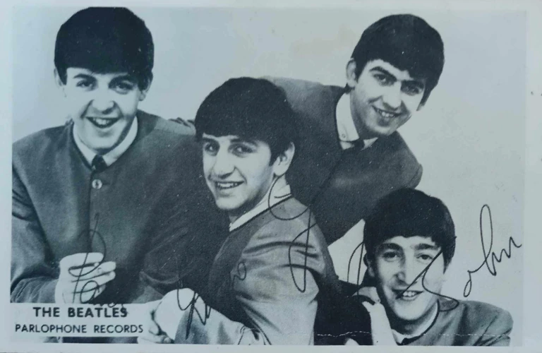 Her dad's only souvenir from the concert was a Parlophone Records postcard. Photo / The Spinoff