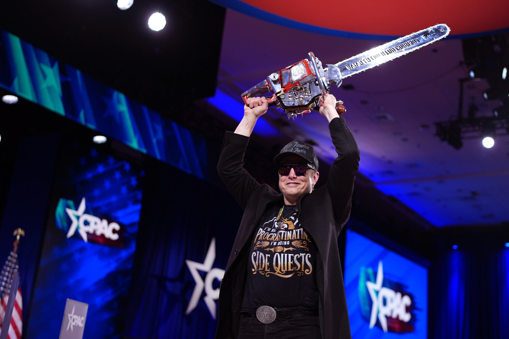 Tesla and SpaceX CEO Elon Musk leaves the stage holding a chainsaw after speaking at the Conservative Political Action Conference (CPAC) conference on February 20. Photo / Getty Images