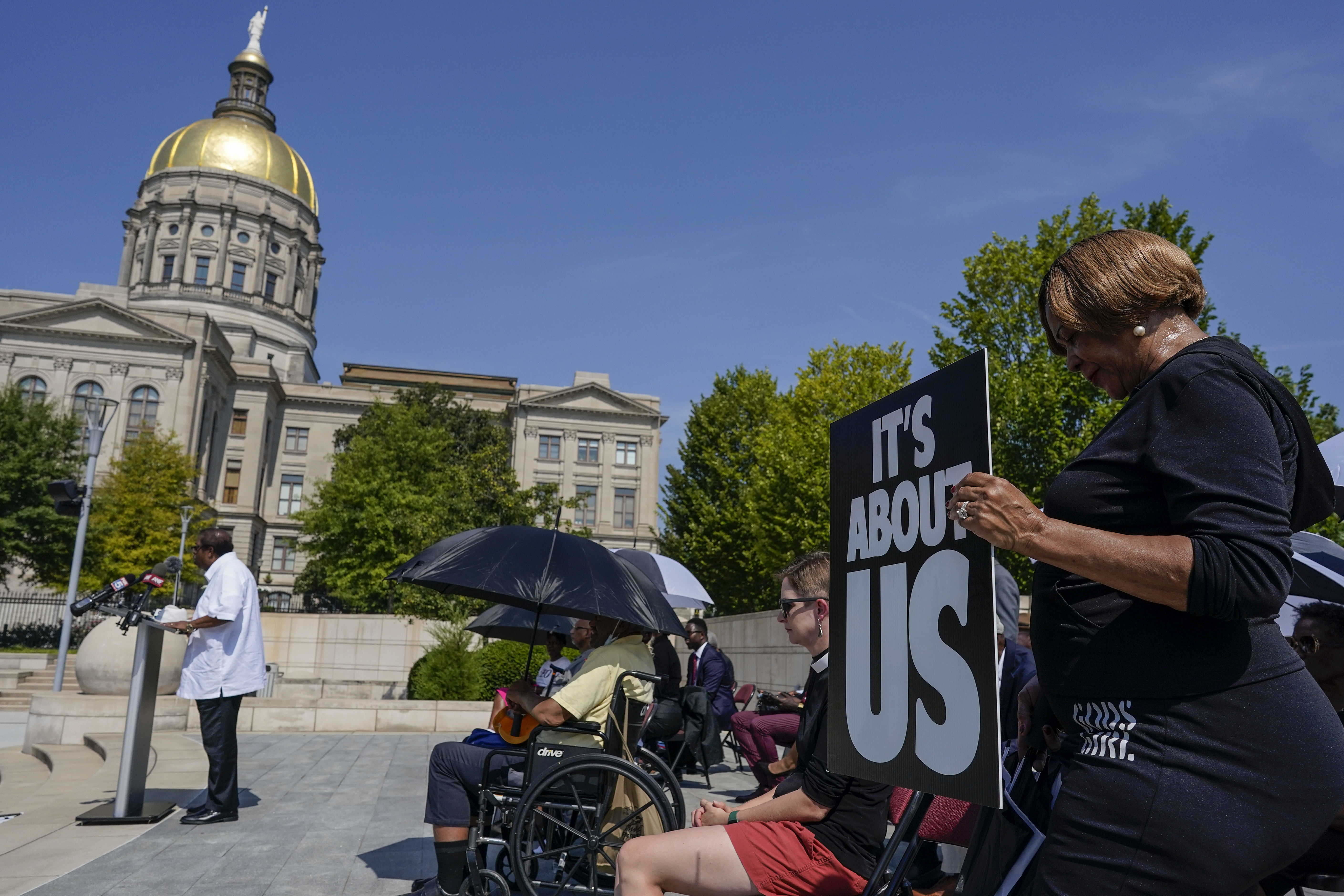 A woman prays in support of Fulton County District Attorney Fani Willis and others inside the court system during a prayer vigil and rally. Photo / AP