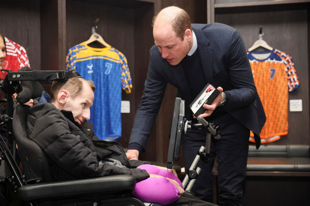 Prince William meets former rugby league player Rob Burrow to congratulate him for raising awareness of motor neurone disease and award him with the Commander of the British Empire (CBE). Photo / Getty Images