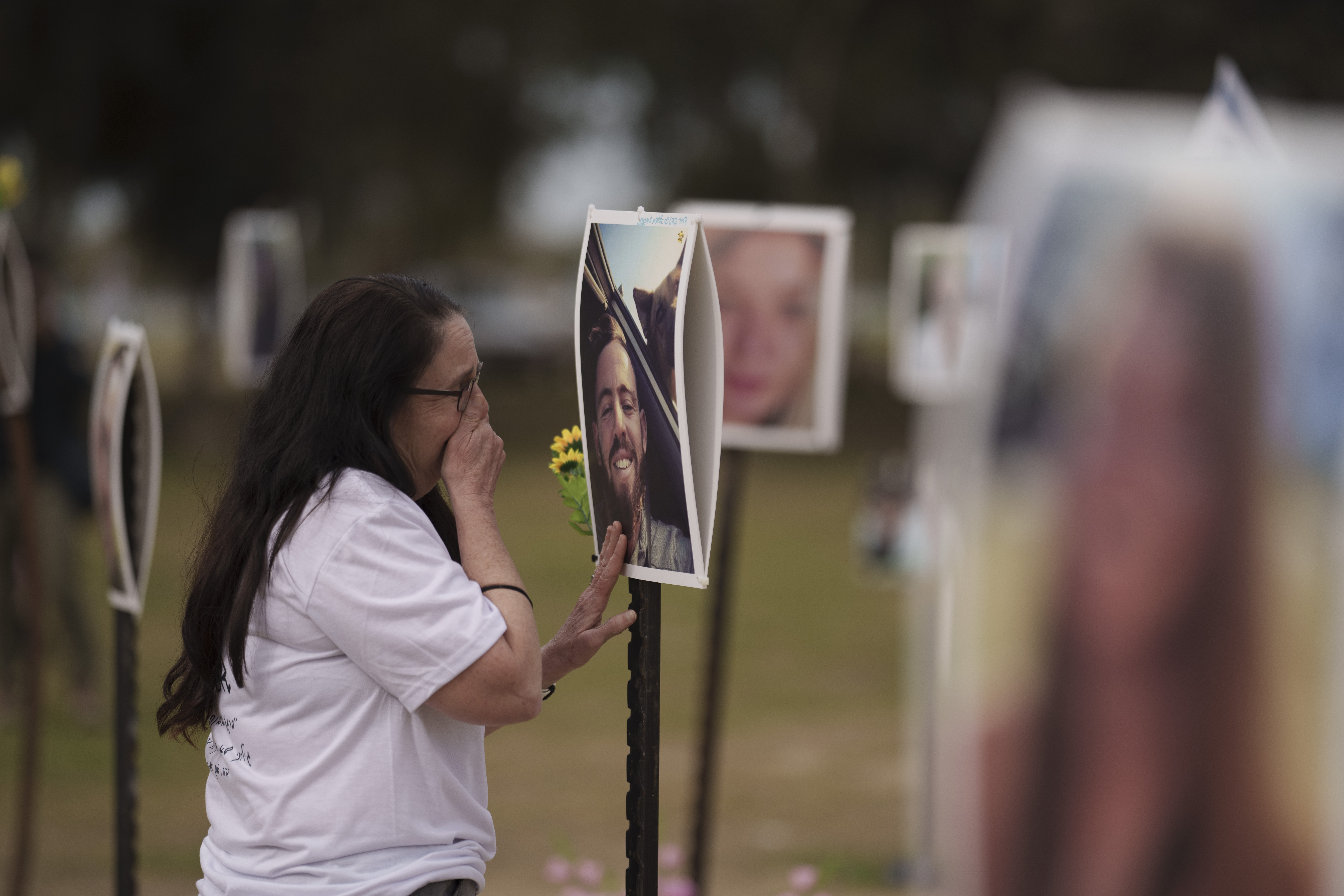 Ela Bahat touches a picture of her 30-year-old son Dror, who was killed at the Nova music festival in Re'im, southern Israel. Photo / AP