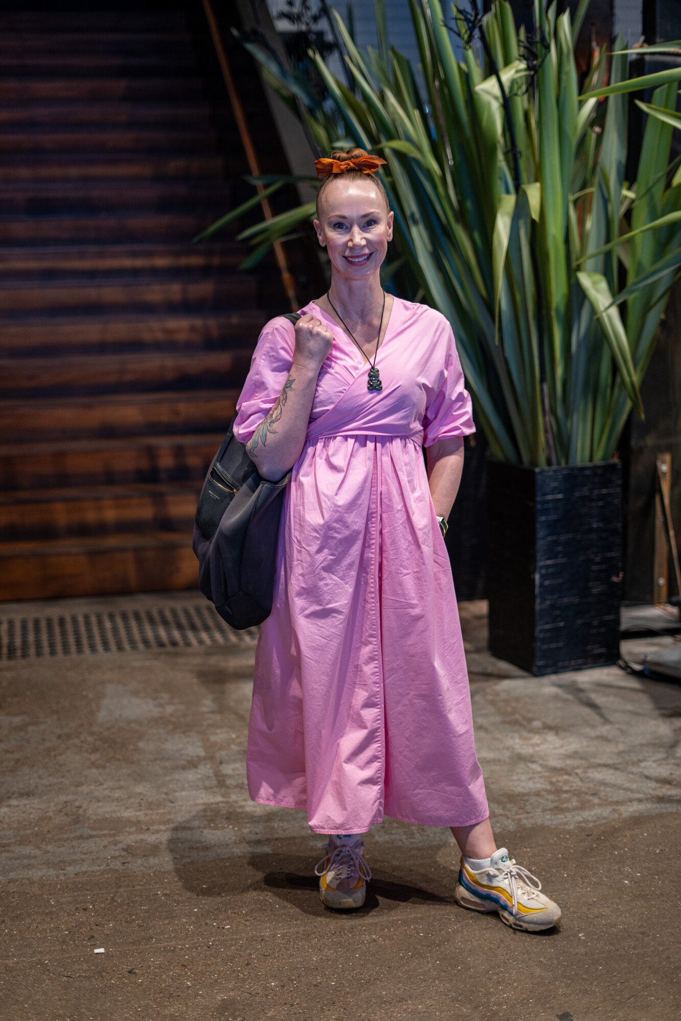 Trudie Kareko wears a pink Kowtow dress, Nike sneakers and a Deadly Ponies bag. Photo / Alyse Wright