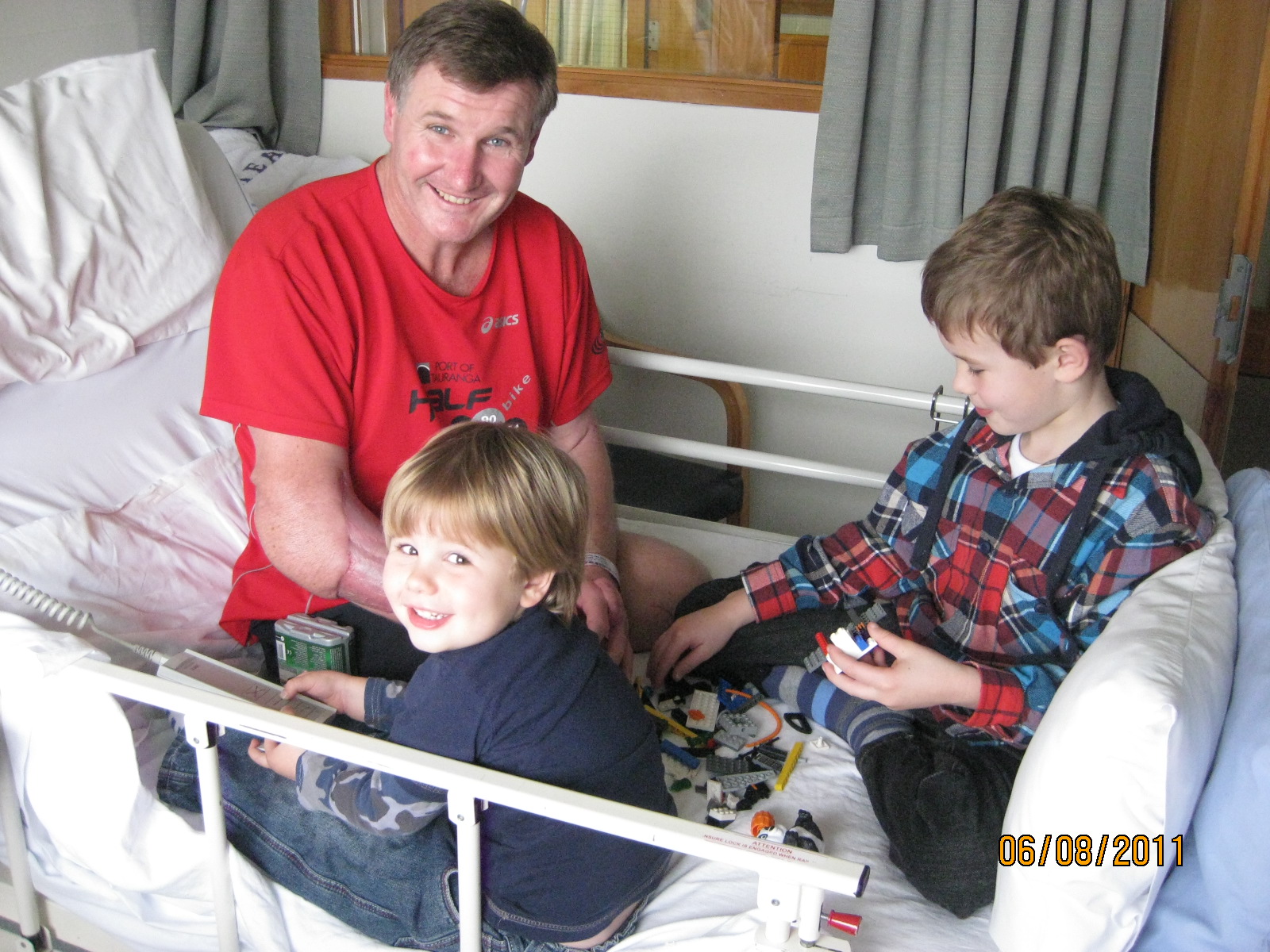 Ian Winson in recovery in 2011 is kept entertained with his sons, Ethan and Joshua. Photo / Supplied