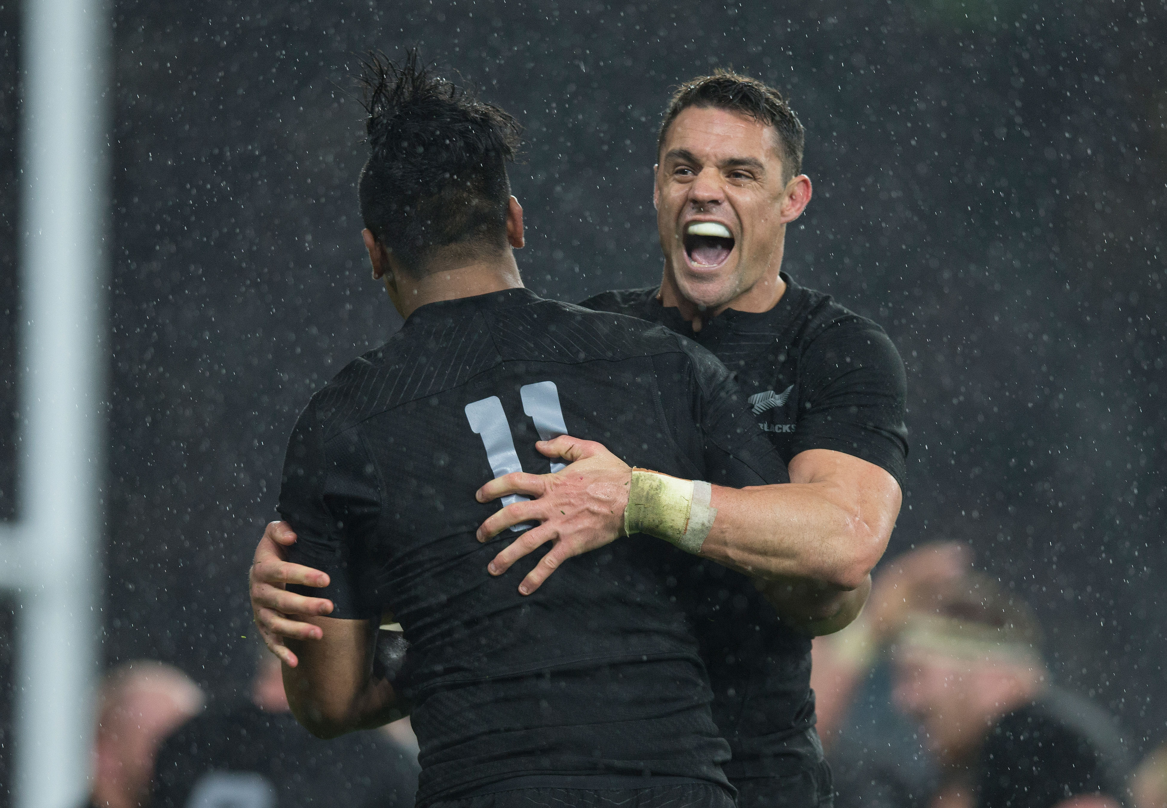 Dan Carter and Julian Savea celebrate the All Blacks' 20-18 win over South Africa. Photo / Brett Phibbs