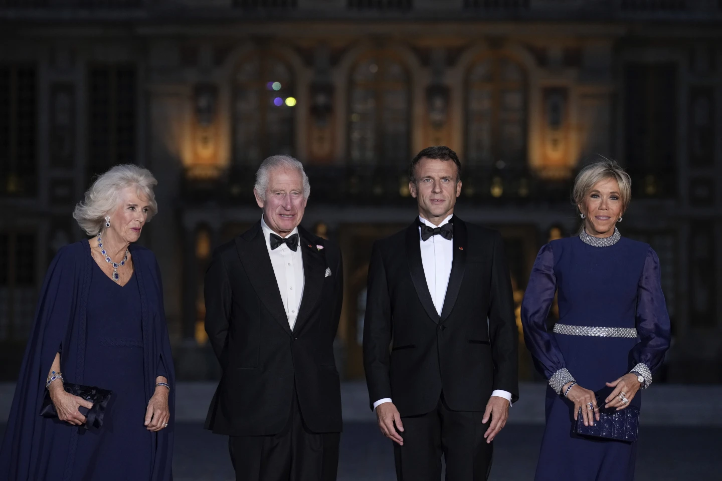 French President Emmanuel Macron, centre right, his wife Brigitte Macron, right, Britain's King Charles III, centre left, and Queen Camilla arrive for a state dinner, at the Chateau de Versailles, west of Paris. Photo / AP