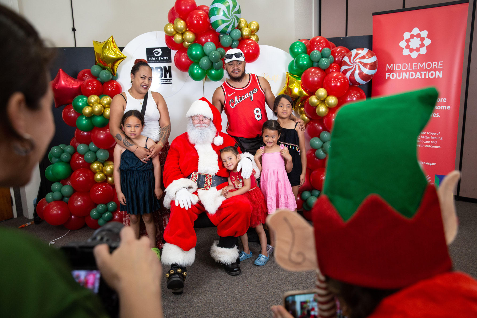 The Te Haki family have a photo with Santa at the Kidz First Christmas Party, Seventh Day Adventist Church, Papatoetoe. The celebration, organised by Kidz First, Dave Letele and BBM, and the Middlemore Foundation brings Christmas cheer to sick and disabled children in South Auckland. Photo / Sylvie Whinray