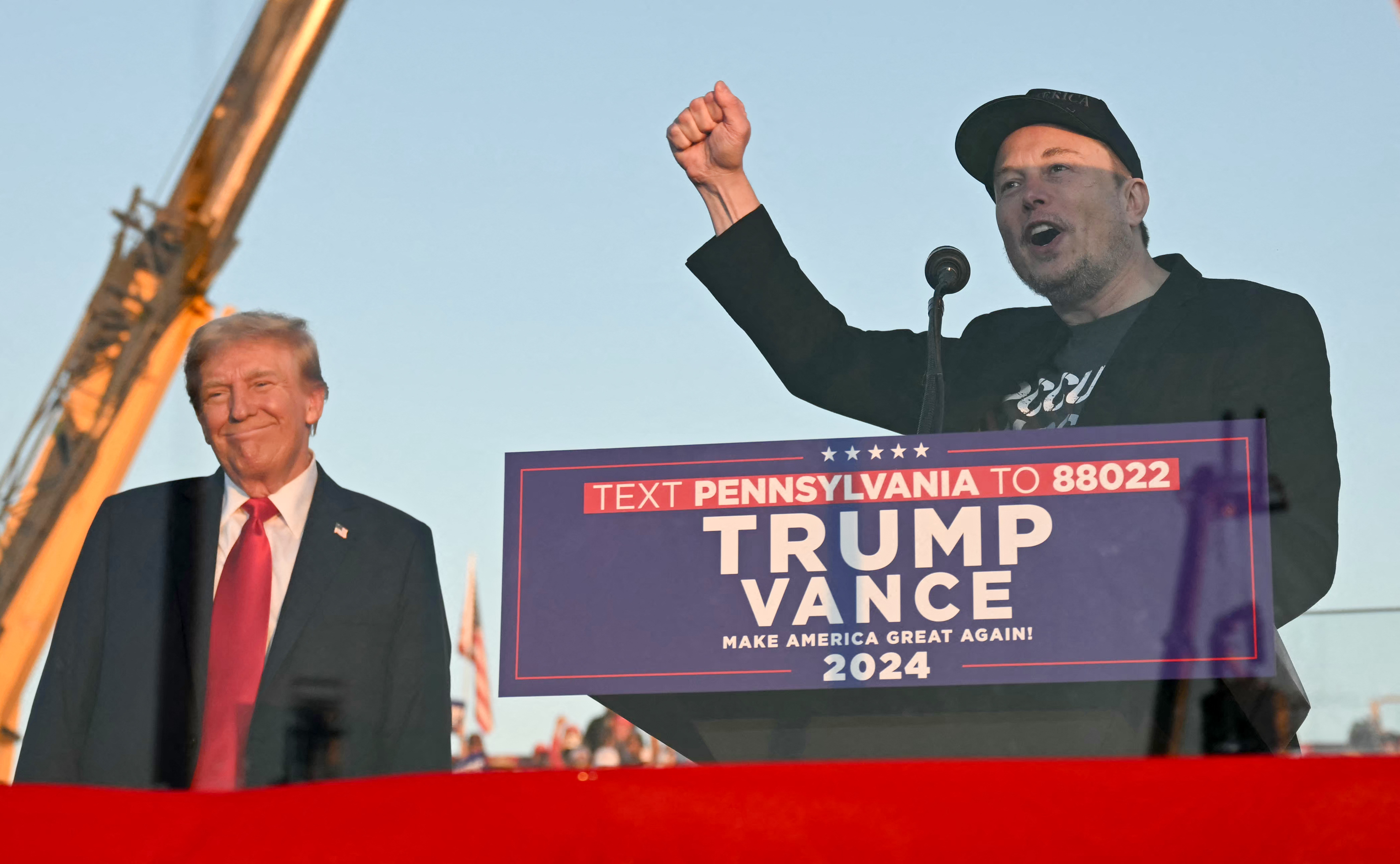 Donald Trump (left) at a rally in Pennsylvania, with Elon Musk (right), who says the election is a “must-win situation” for Trump and the nation. Photo / AFP