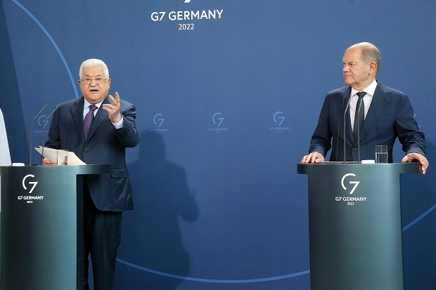 Palestinian President Mahmoud Abbas, left, speaks during a news conference after a meeting with German Chancellor Olaf Scholz, right. Photo / AP