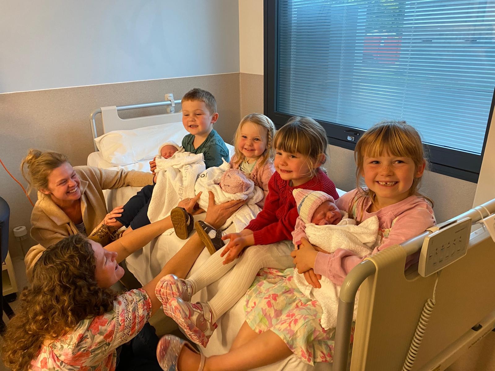 The Pyle identical triplet sisters, Sophia, Adeline and Gabriella, with their delighted big siblings James, Olivia, Georgia and Eliane.