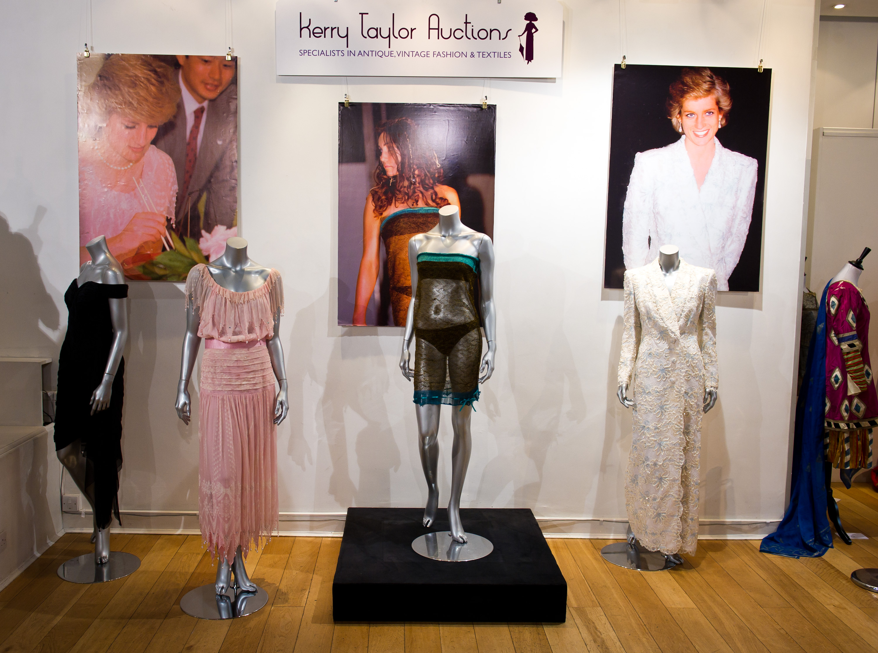 The Zandra Rhodes pink chiffon dinner gown worn by Diana, Princess of Wales, the see-through knitted dress designed by Charlotte Todd which was worn by Kate Middleton at the annual St. Andrews University charity fashion show in 2002 and the Catherine Walker formal white lace evening gown worn by HRH the Princess of Wales for a state visit to France in November 1998. Photo / Getty Images