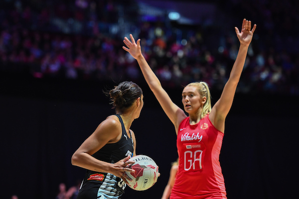 English star Helen Housby, pictured facing off against Silver Fern Phoenix Karaka, plays in the Australian Super netball competition. Photo / Photosport