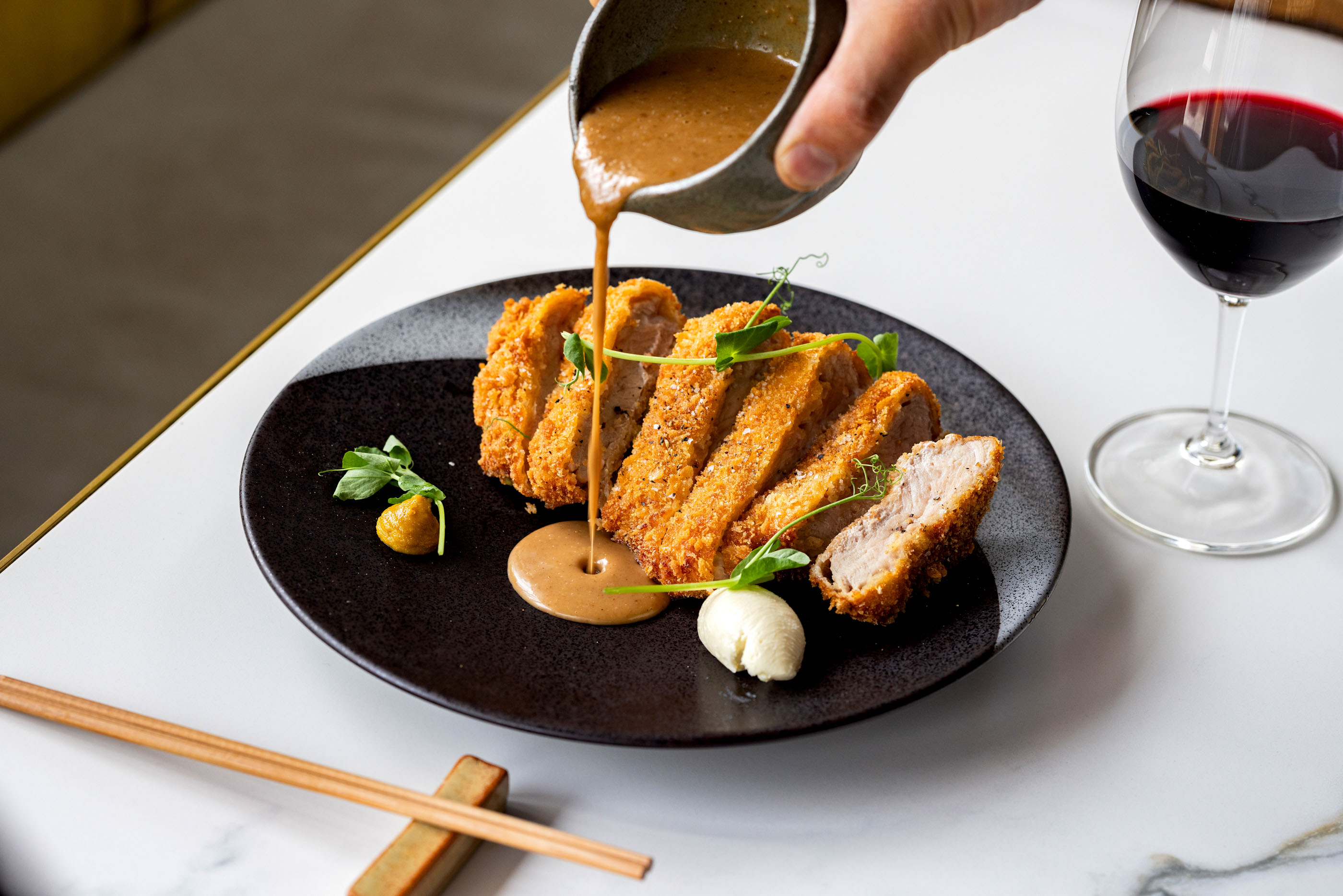 Wakuwaku’s tonkatsu with karashi Japanese mustard and parmesan creme fraiche. Photo / Babiche Martens