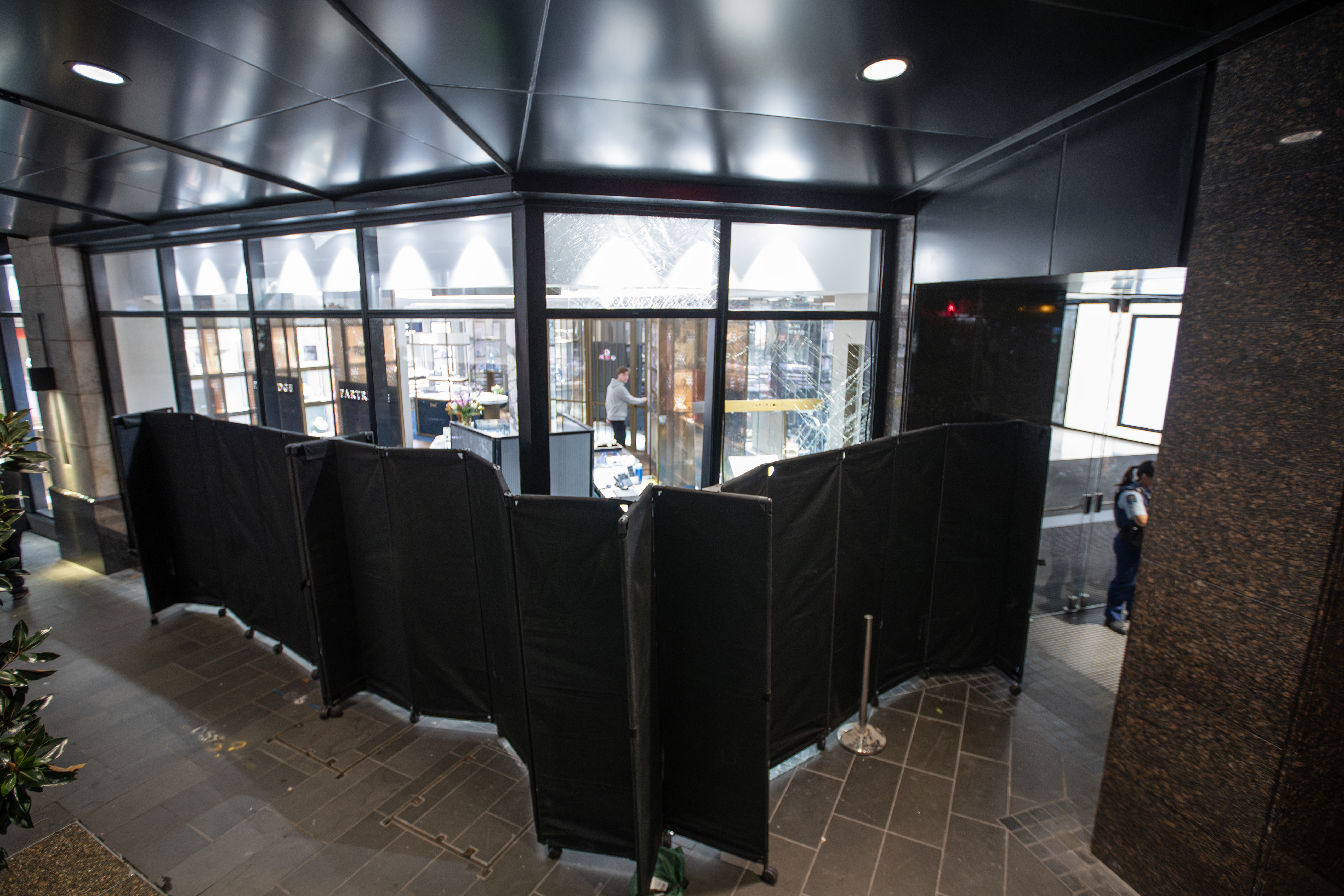 Security staff have erected screens to prevent people seeing inside the store. Photo / Hayden Woodward