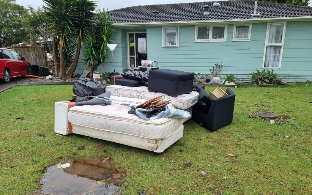 Flood-damaged items in the backyard of a Māngere house. Photo / Jonty Dine, RNZ
