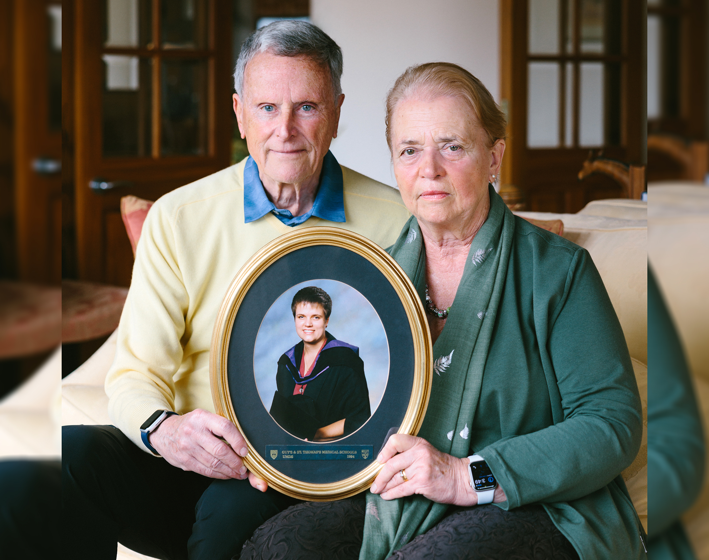 Sid Miller and his wife Christine Miller hold a portrait of their daughter Dr Heidi MacRae, who died in November 2022 after battling triple negative breast cancer.