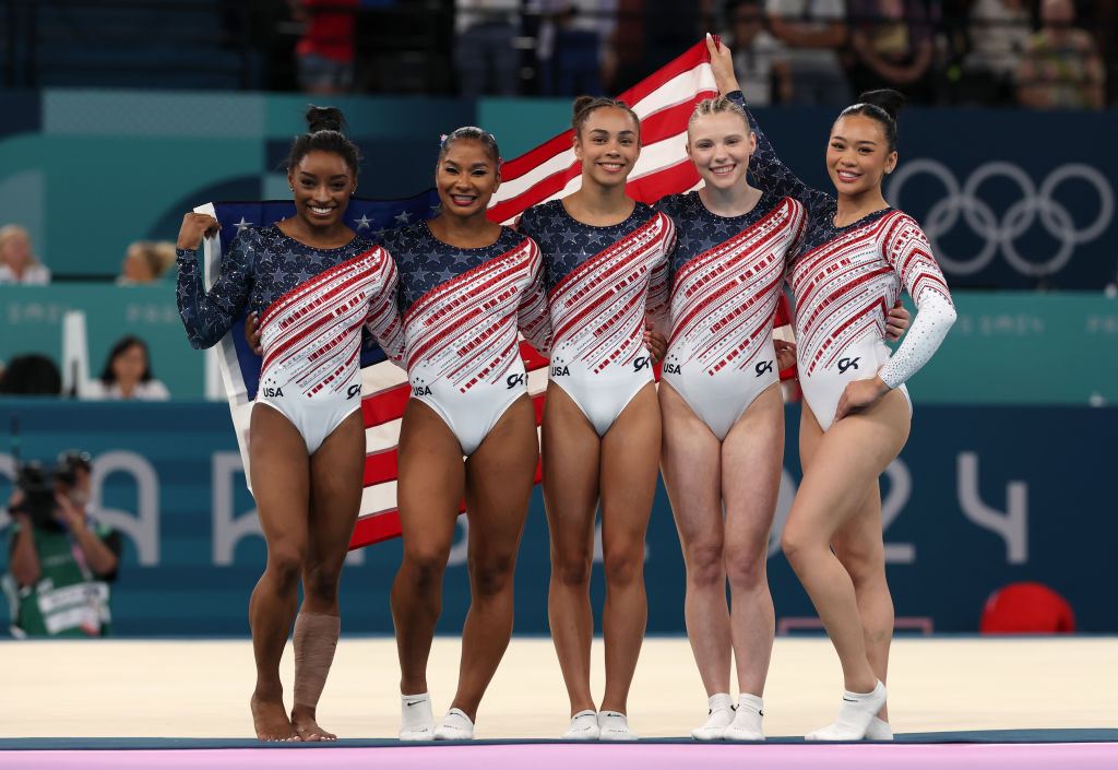 Simone Biles, Jordan Chiles, Hezly Rivera, Jade Carey and Sunisa Lee of Team United States celebrate after winning the gold medal during the Artistic Gymnastics women's team final on day four of the Olympic Games. Photo / Getty Images