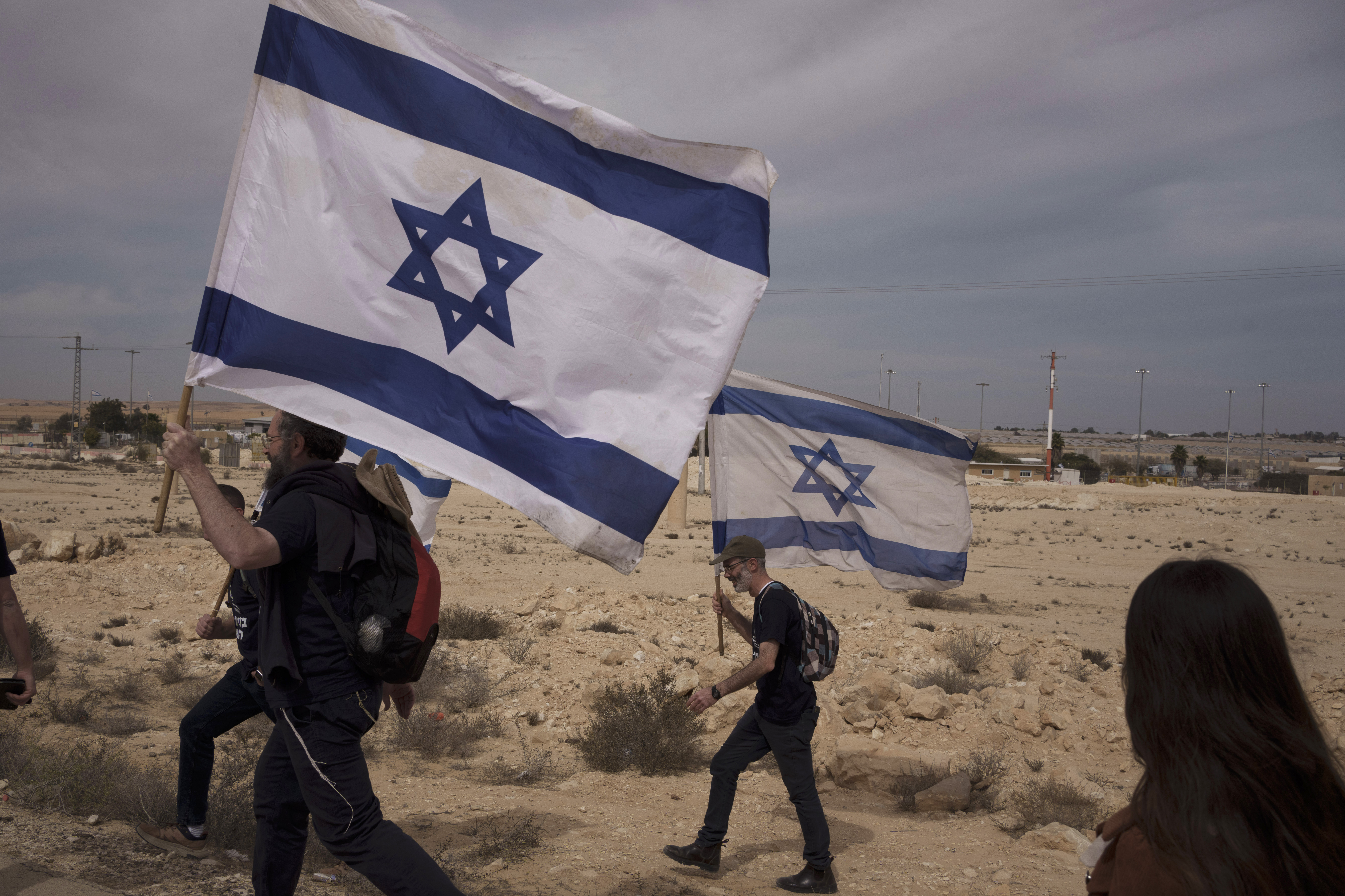 People walk toward the Nitzana border crossing with Egypt in southern Israel, on Monday, February 12, 2024, protesting against the humanitarian aid to enter Gaza until all the hostages are released. Photo / AP