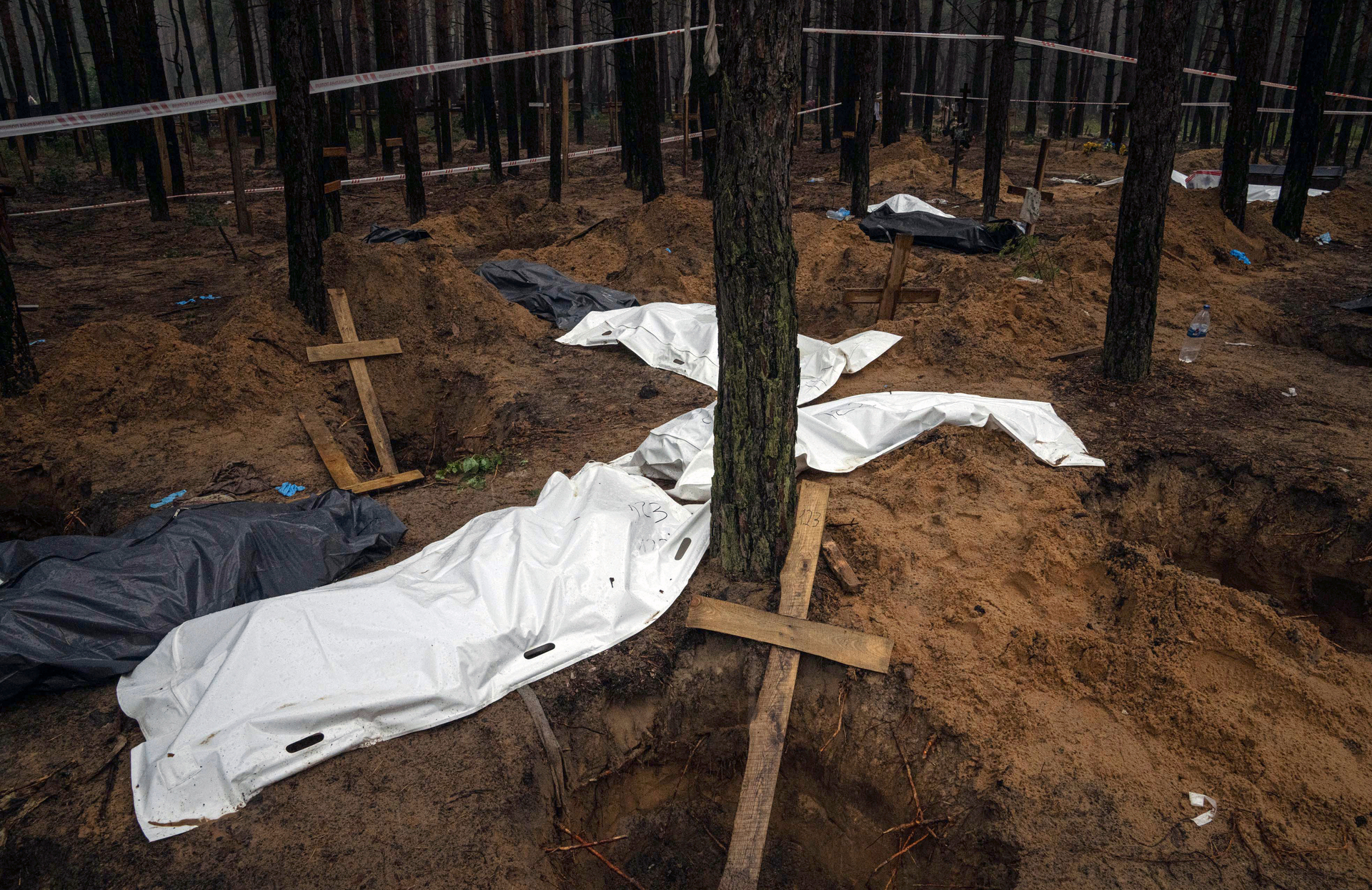 Bags with dead bodies are seen during the exhumation in the recently retaken area of Izium, Ukraine on Friday. Photo / AP