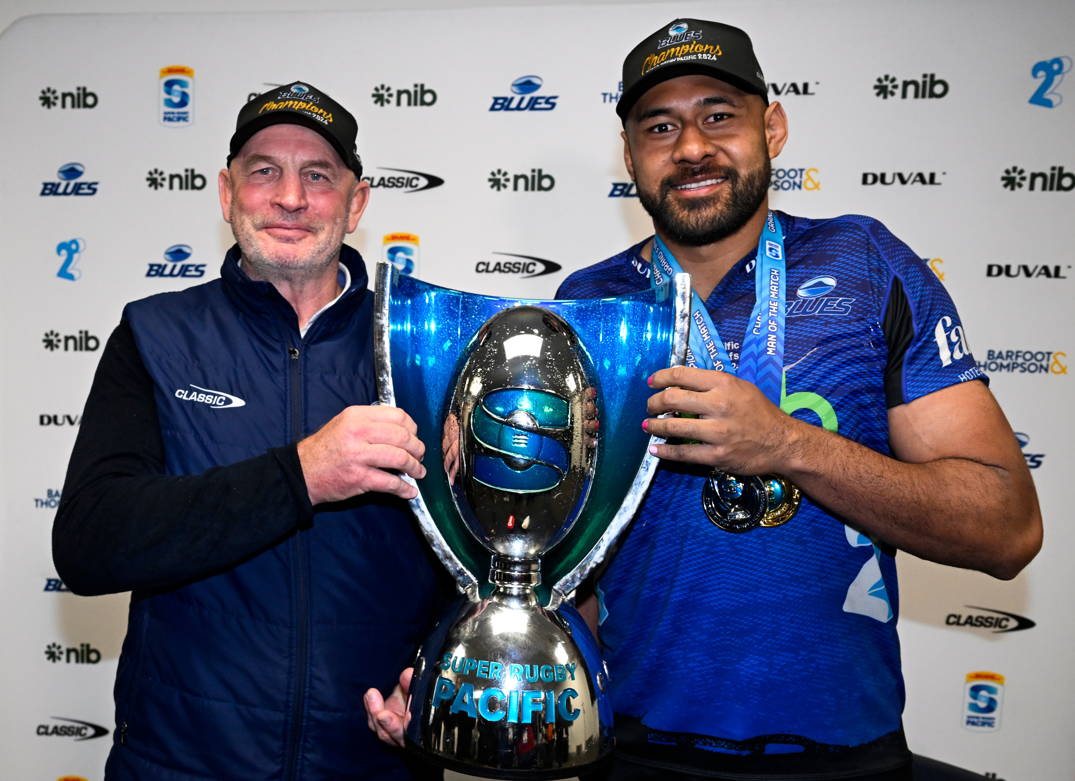 Vern Cotter and Patrick Tuipulotu with the Super Rugby Pacific trophy. Photo / Photosport