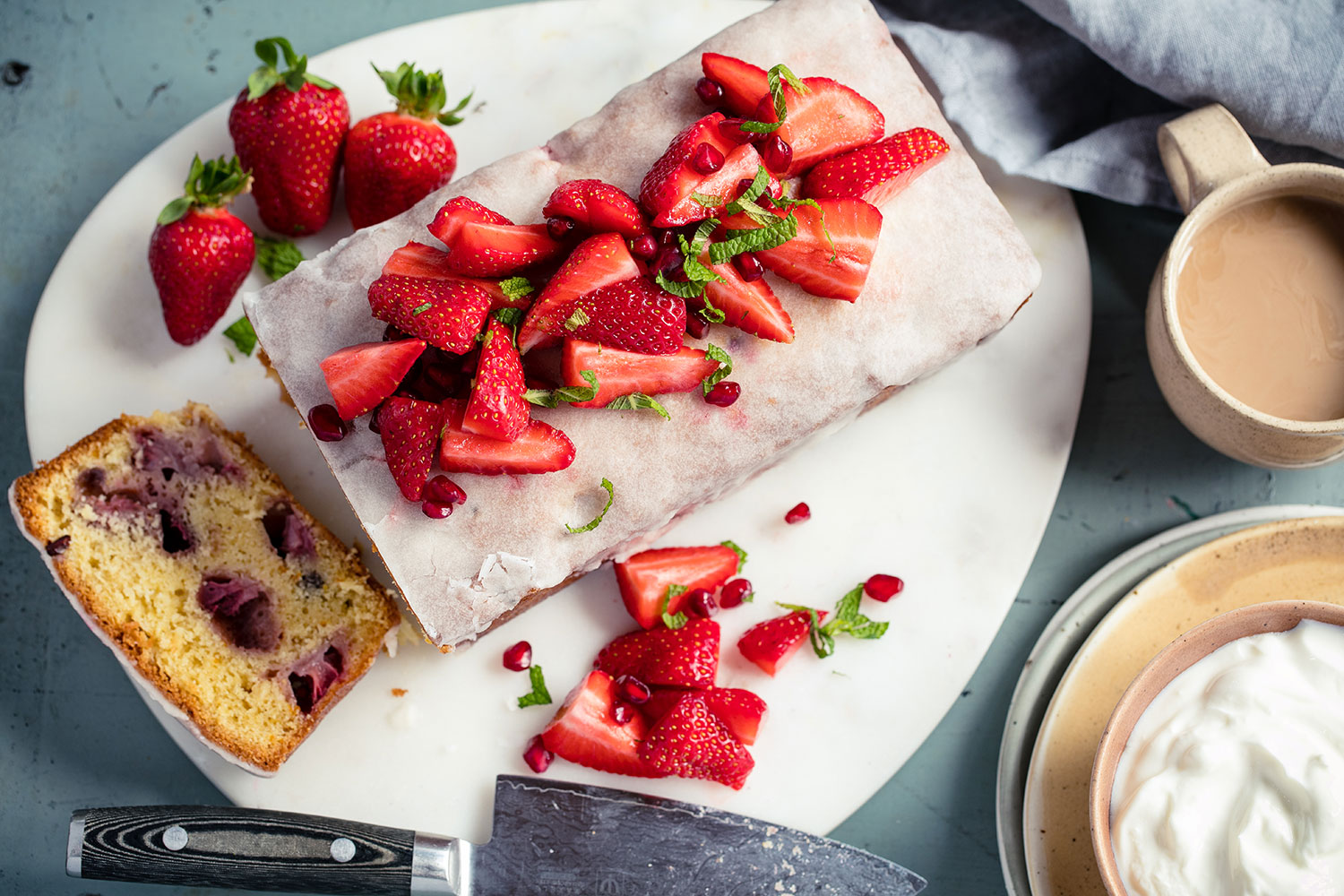 Serve this strawberry and pomegranate loaf with a dollop of yoghurt. Photo / Babiche Martens
