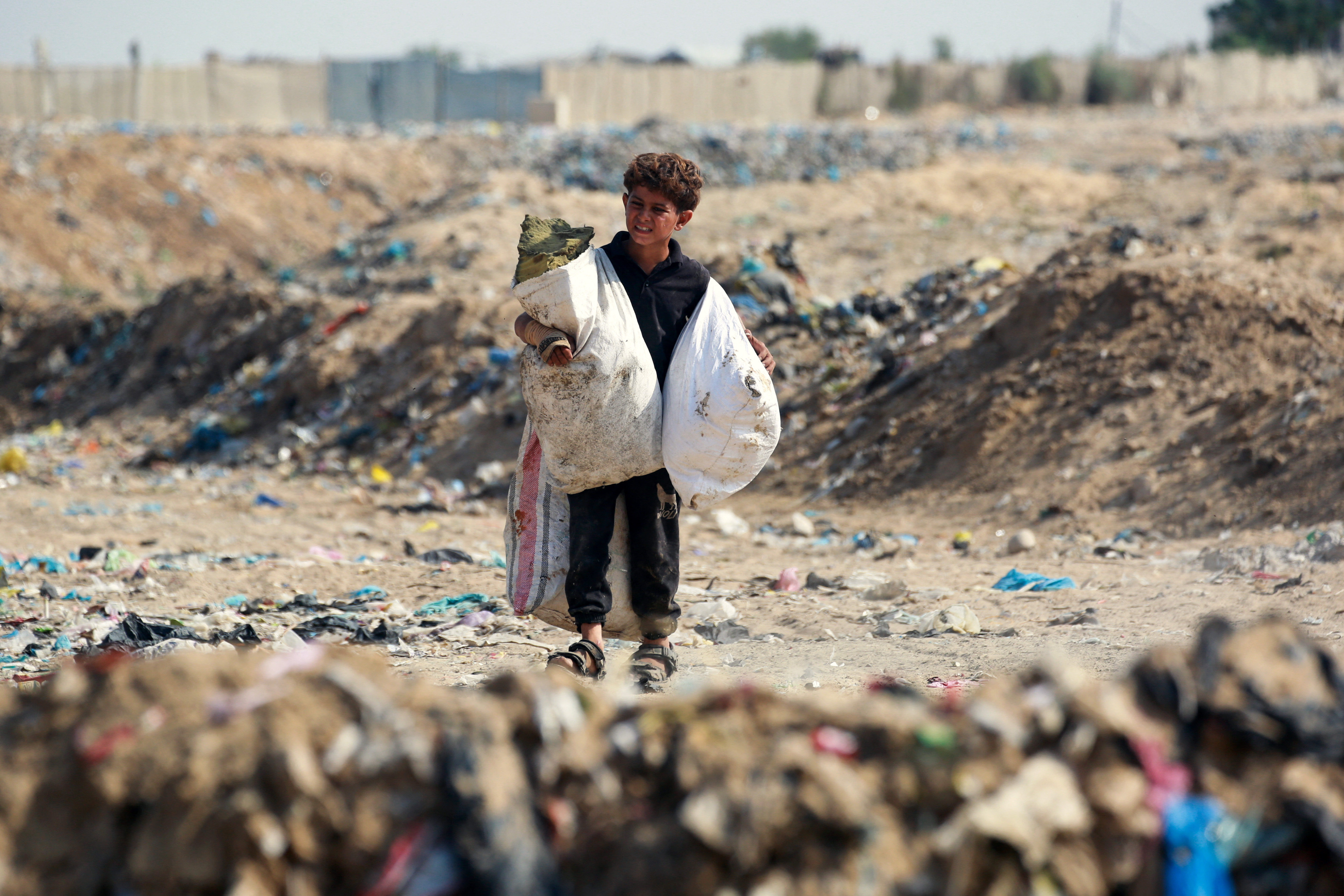 A boy carries bags after sifting through waste at a landfill in Khan Yunis in the southern Gaza Strip on October 15, 2024. Photo / AFP