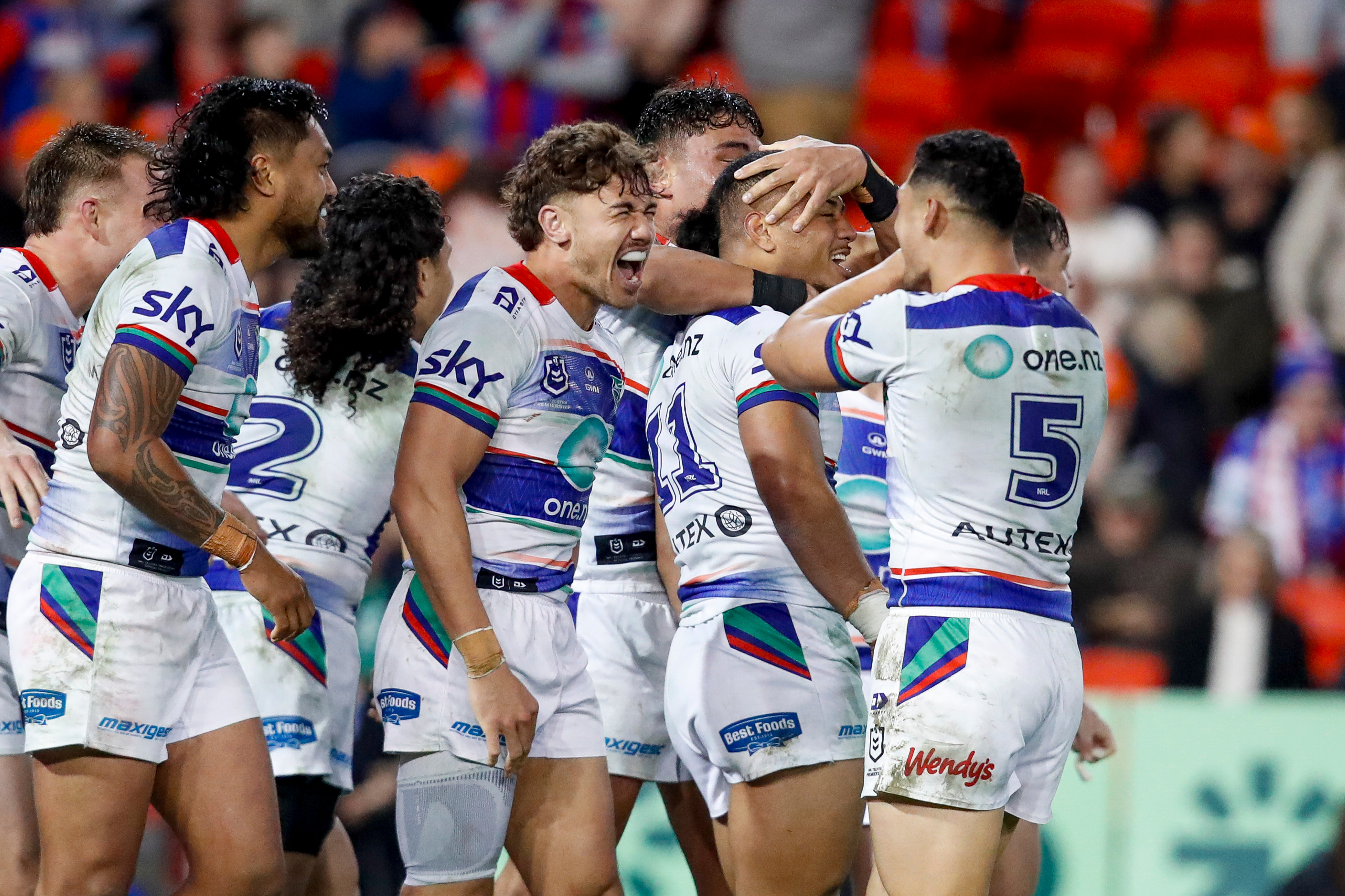 Leka Halasima celebrates with teammates after scoring the game-winning try against the Warriors. Photo / Photosport