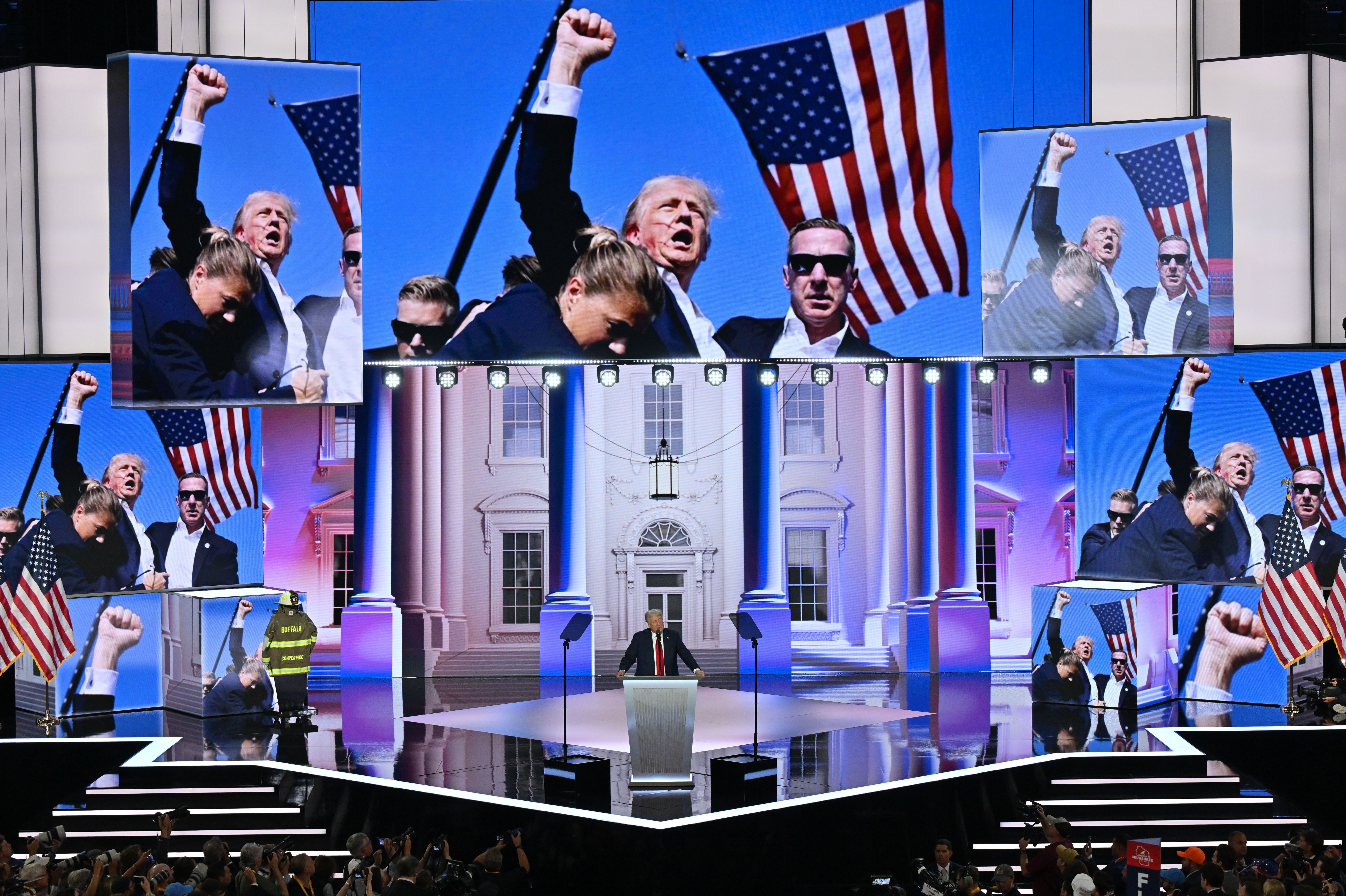Screens show a photo of Donald Trump after Sunday’s assassination attempt as he accepts his party’s presidential nomination at the Republican National Convention. Photo / Washington Post