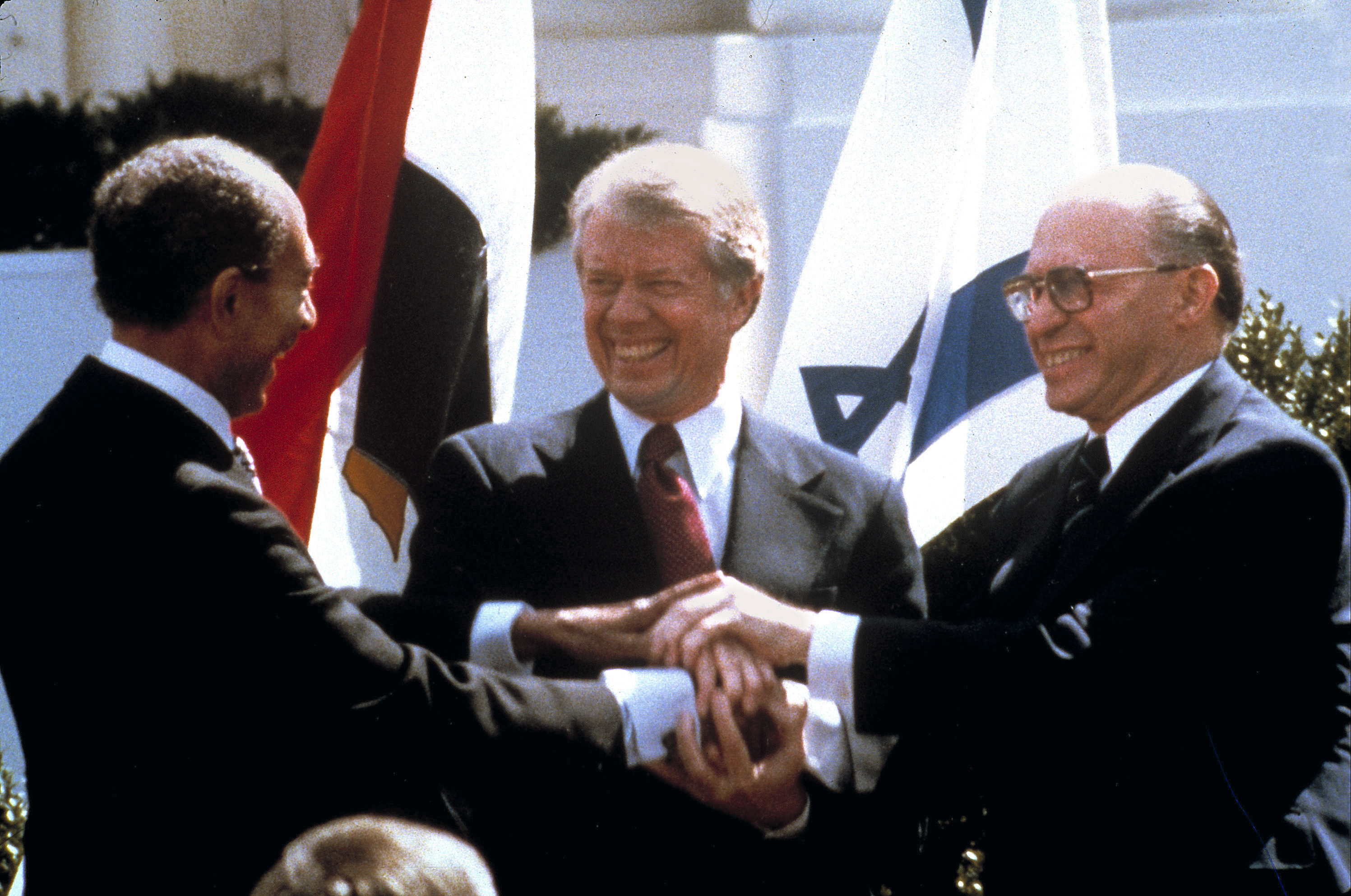 Egyptian President Anwar Sadat (left), US President Jimmy Carter (centre) and Israeli Prime Minister Menachem Begin clasp hands on the north lawn of the White House as they complete the signing of the peace treaty between Egypt and Israel in Washington DC on March, 26, 1979. Photo / AP
