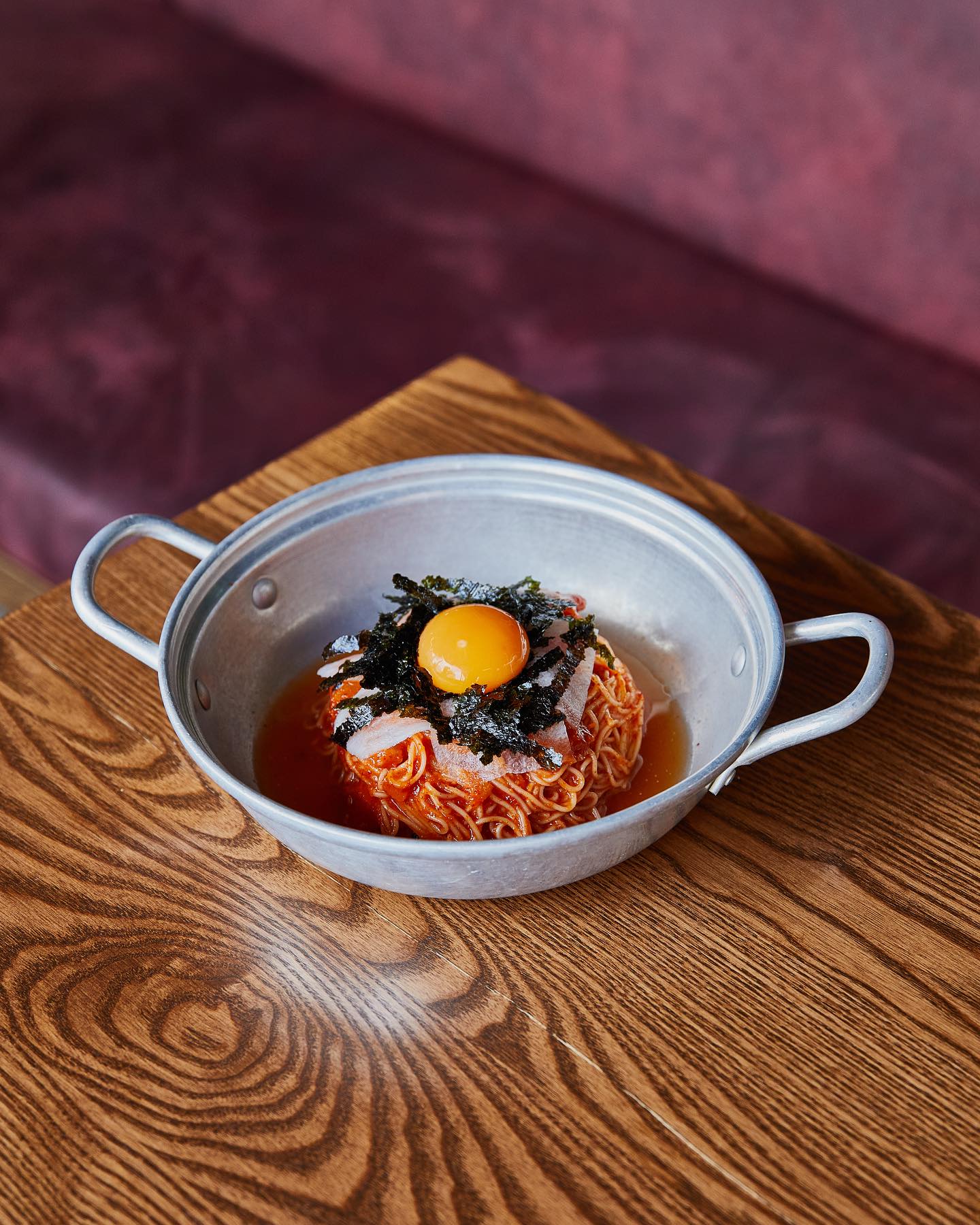 Gochu’s cold noodles with white kimchi, seaweed, egg yolk and pickled radish. Photo / @Gochugotyou