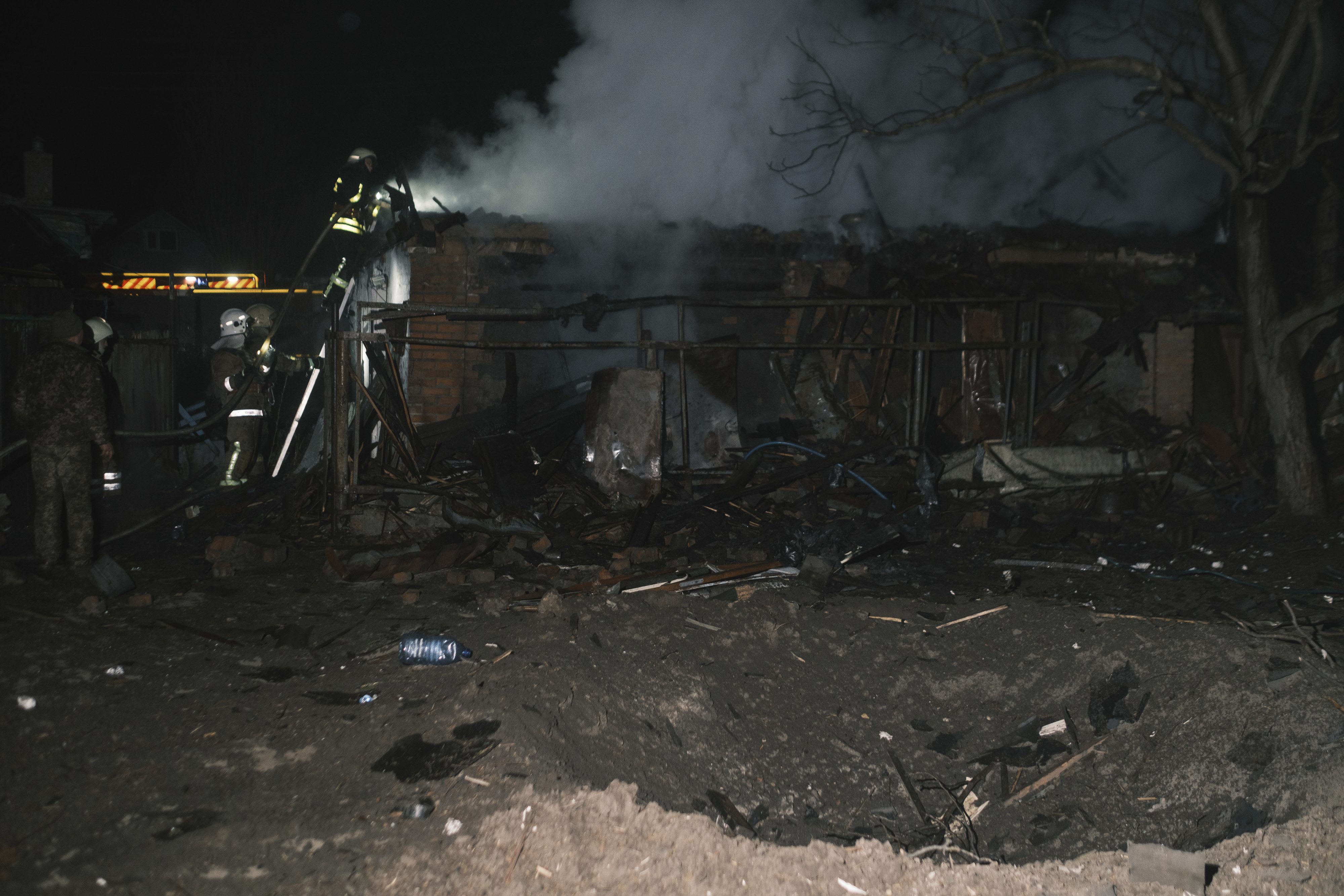 Rescue workers battle a blaze in a destroyed house after a Russian drone strike on a residential neighbourhood in Kharkiv. Photo / AP