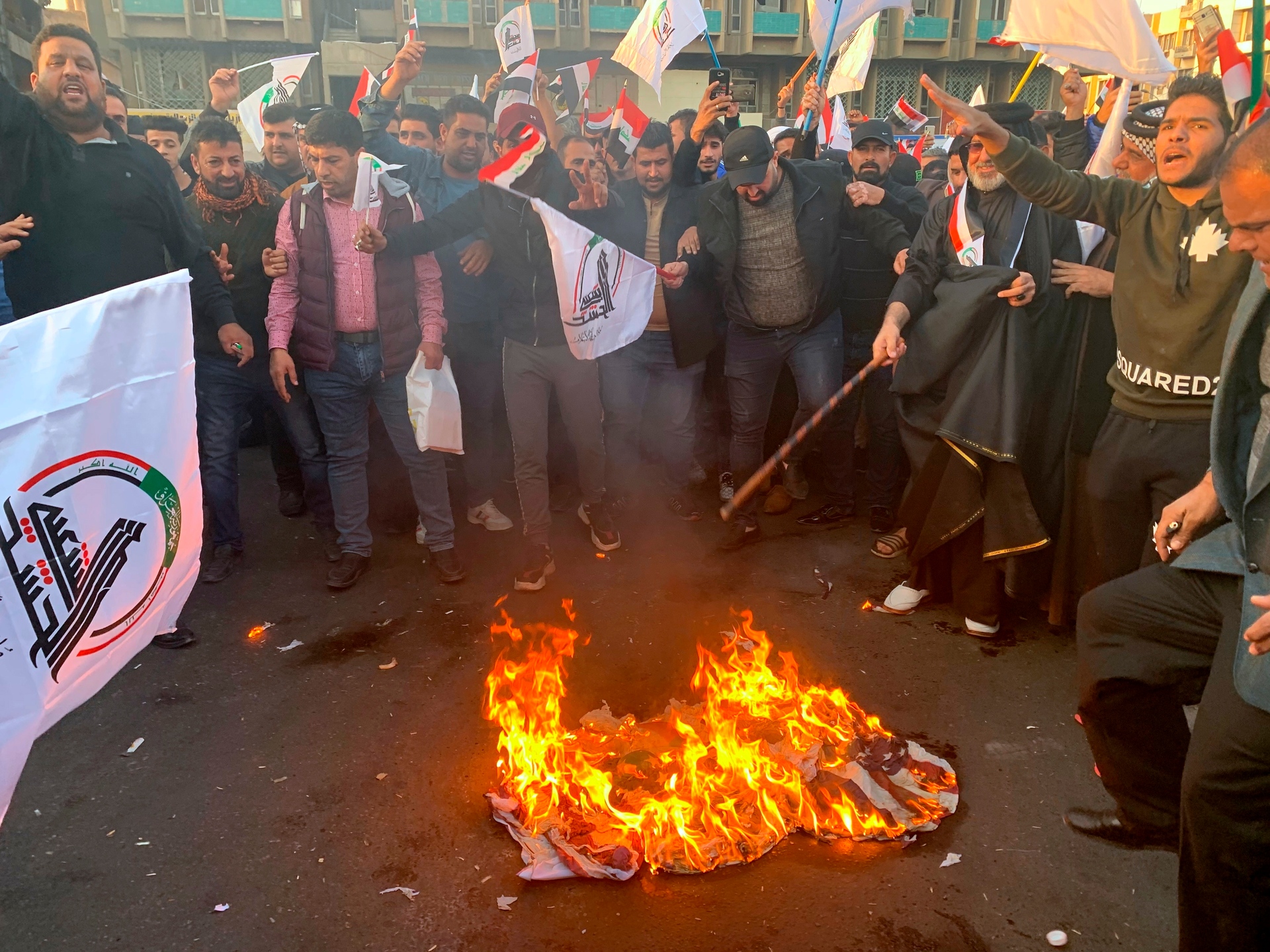 Protesters burn representations of a US flag during a protest against the US strikes on the Hezbollah Brigades militia, in Tahrir Square, Baghdad, Iraq. Photo / AP