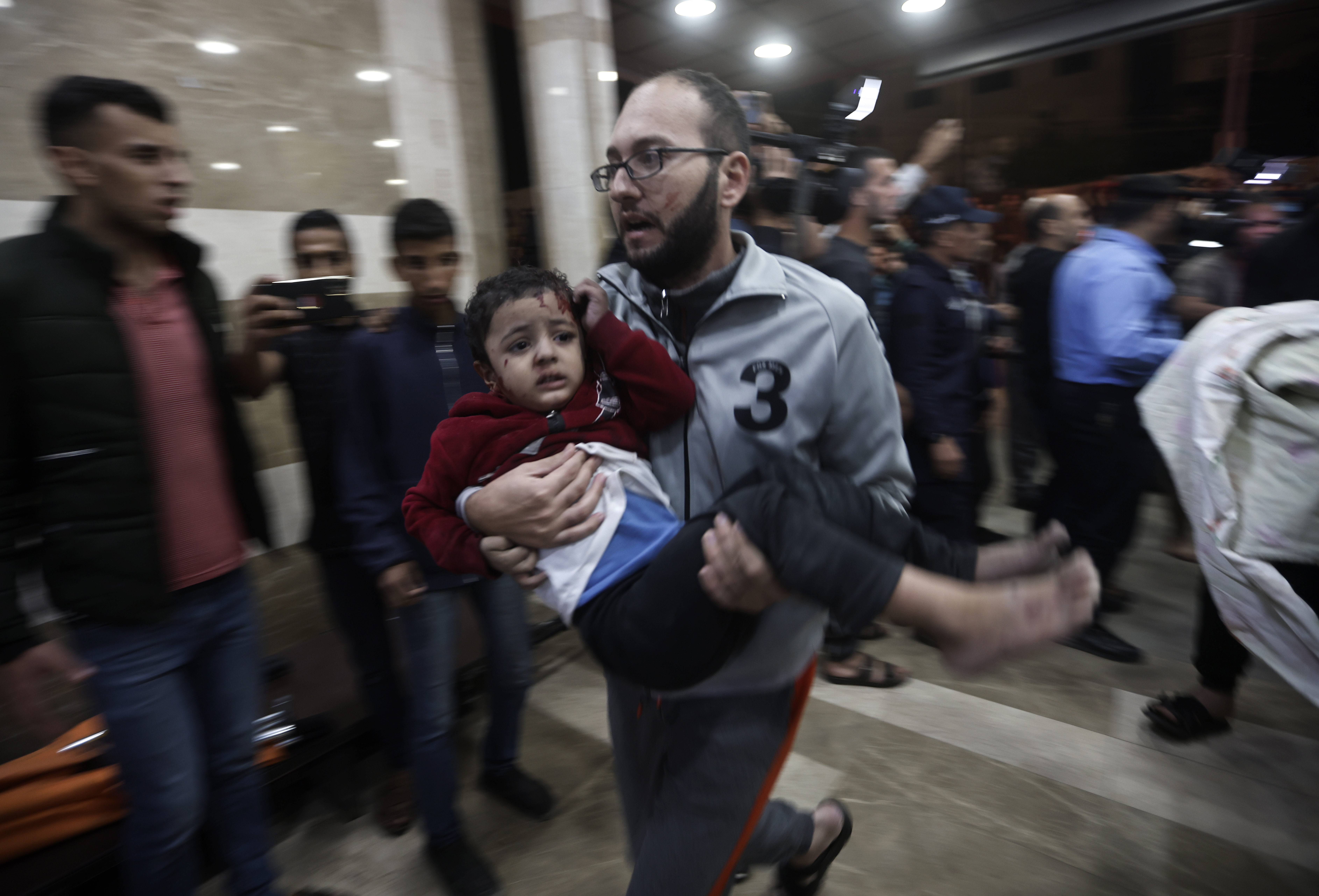 A wounded Palestinian child is carried into the Nasser Hospital following an Israeli bombardment on Khan Younis refugee camp, southern Gaza Strip. Photo / AP