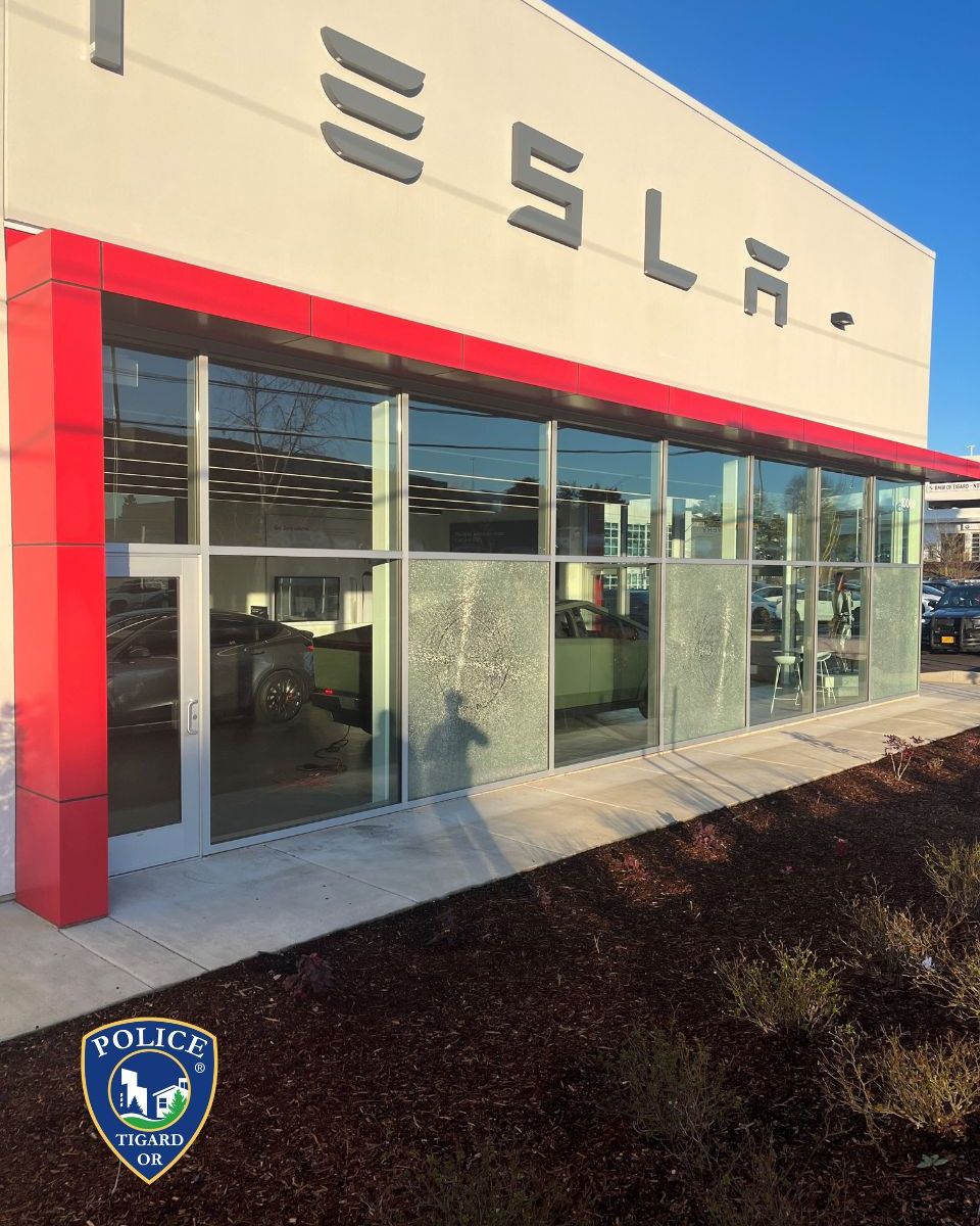Windows shattered by bullets at a Tesla dealership in Tigard, Oregon. Photo / Tigard Police Department