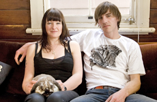 Claire and Greg from Meadowlark jewelry relax on the couch with their resident rabbit. Photo / Babiche Martens